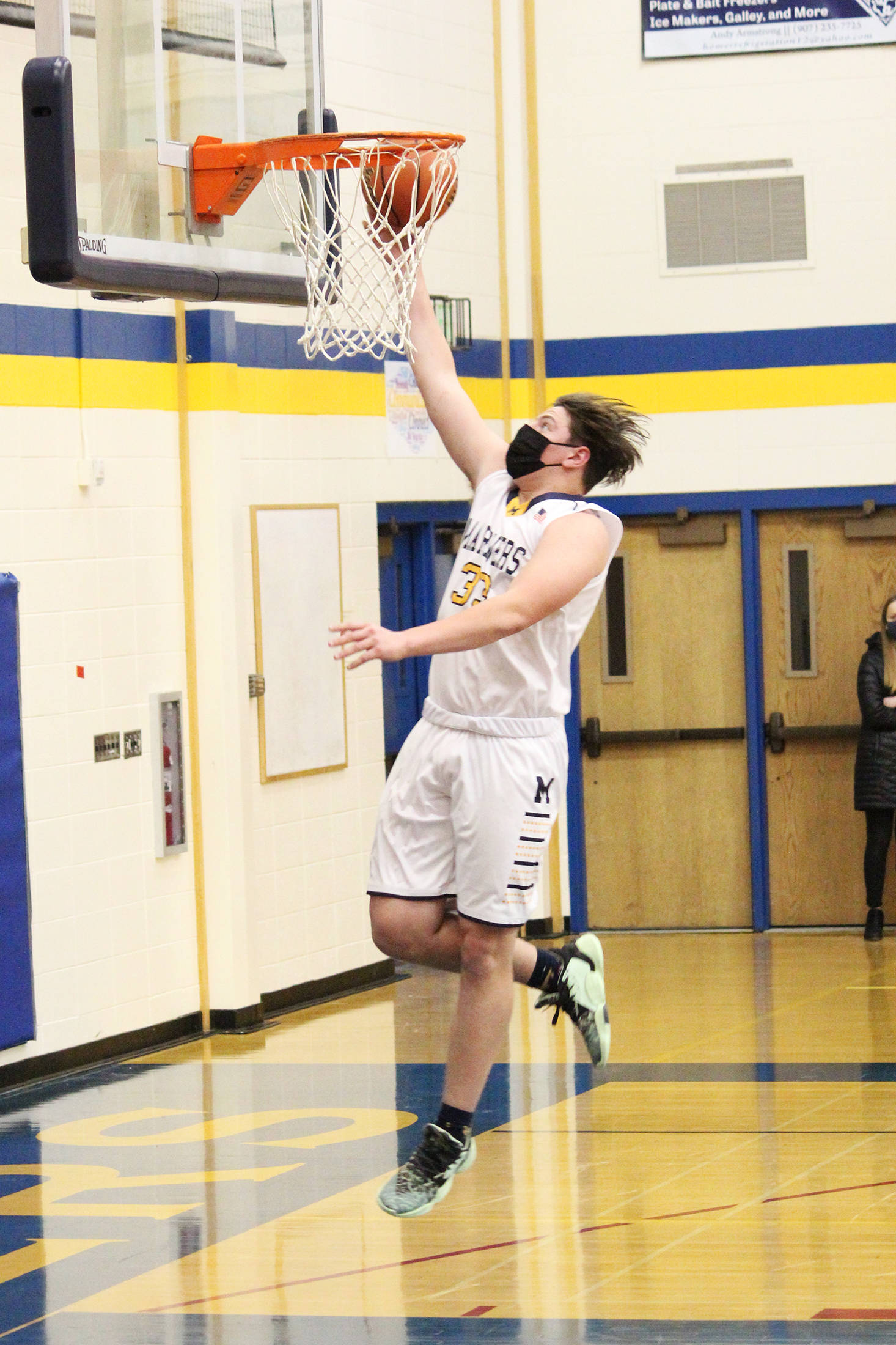 Homer’s Carter Tennison goes up for a shot during a Tuesday, Feb. 9, 2021 basketball game against Kenai Central in the Alice Witte Gymnasium in Homer, Alaska. (Photo by Megan Pacer/Homer News)