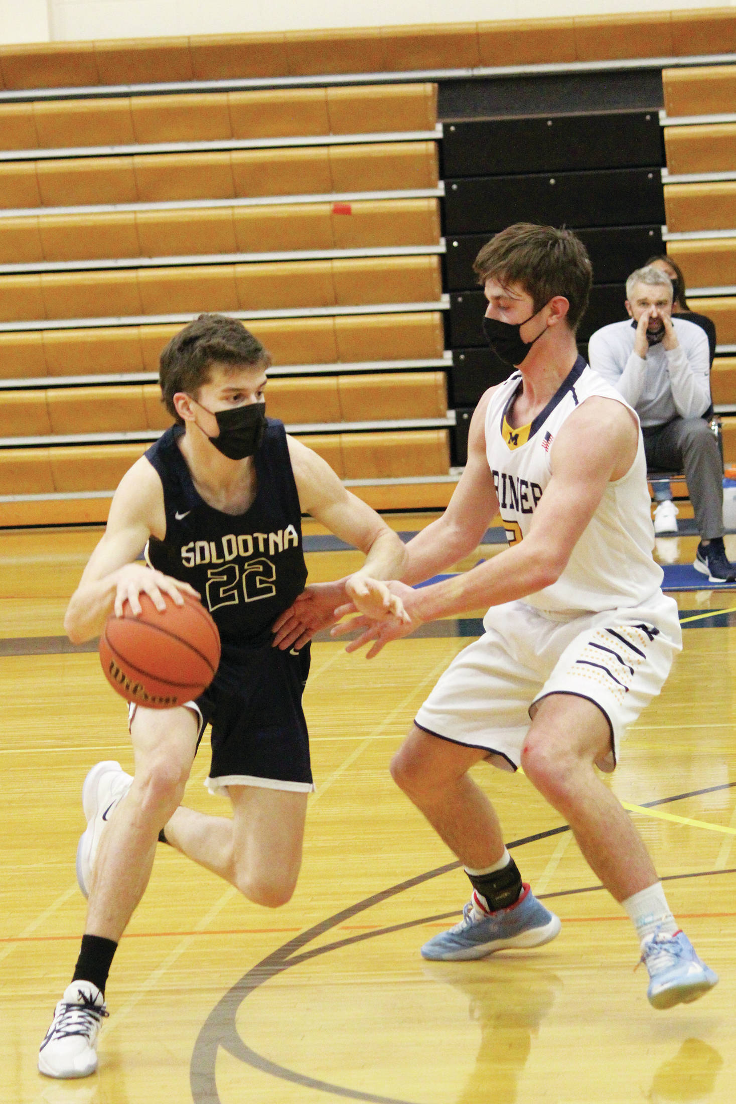 Soldotna’s Ethan Sewell looks for a way around Homer’s Clayton Beachy during a Tuesday, March 2, 2021 basketball game in the Alice Witte Gymnasium in Homer, Alaska. (Photo by Megan Pacer/Homer News)