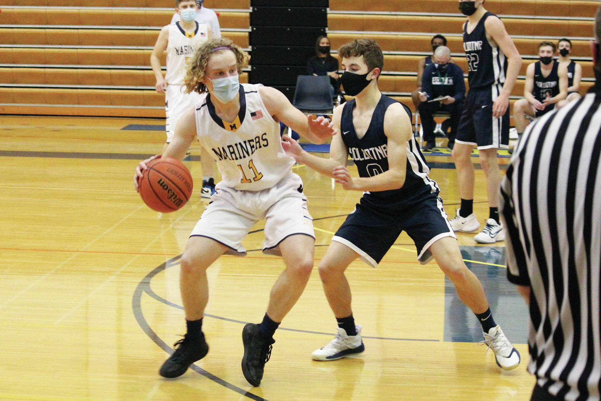Soldotna’s Zac Buckbee defends against Homer’s Parker Lowney during a Tuesday, March 2, 2021 basketball game in the Alice Witte Gymnasium in Homer, Alaska. (Photo by Megan Pacer/Homer News)