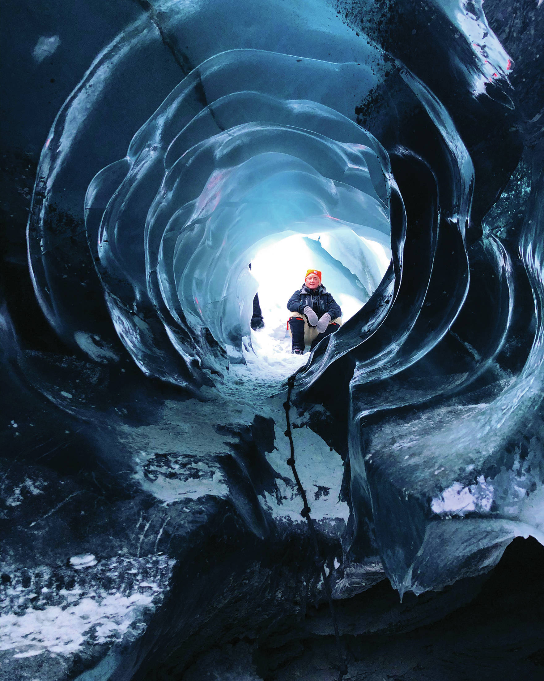 A guide waits for the author to climb through an ice tunnel at the Matanuska Glacier on Jan. 17, 2021 in the Matanuska-Susitna Borough, Alaska. (Photo by Megan Pacer/Homer News)