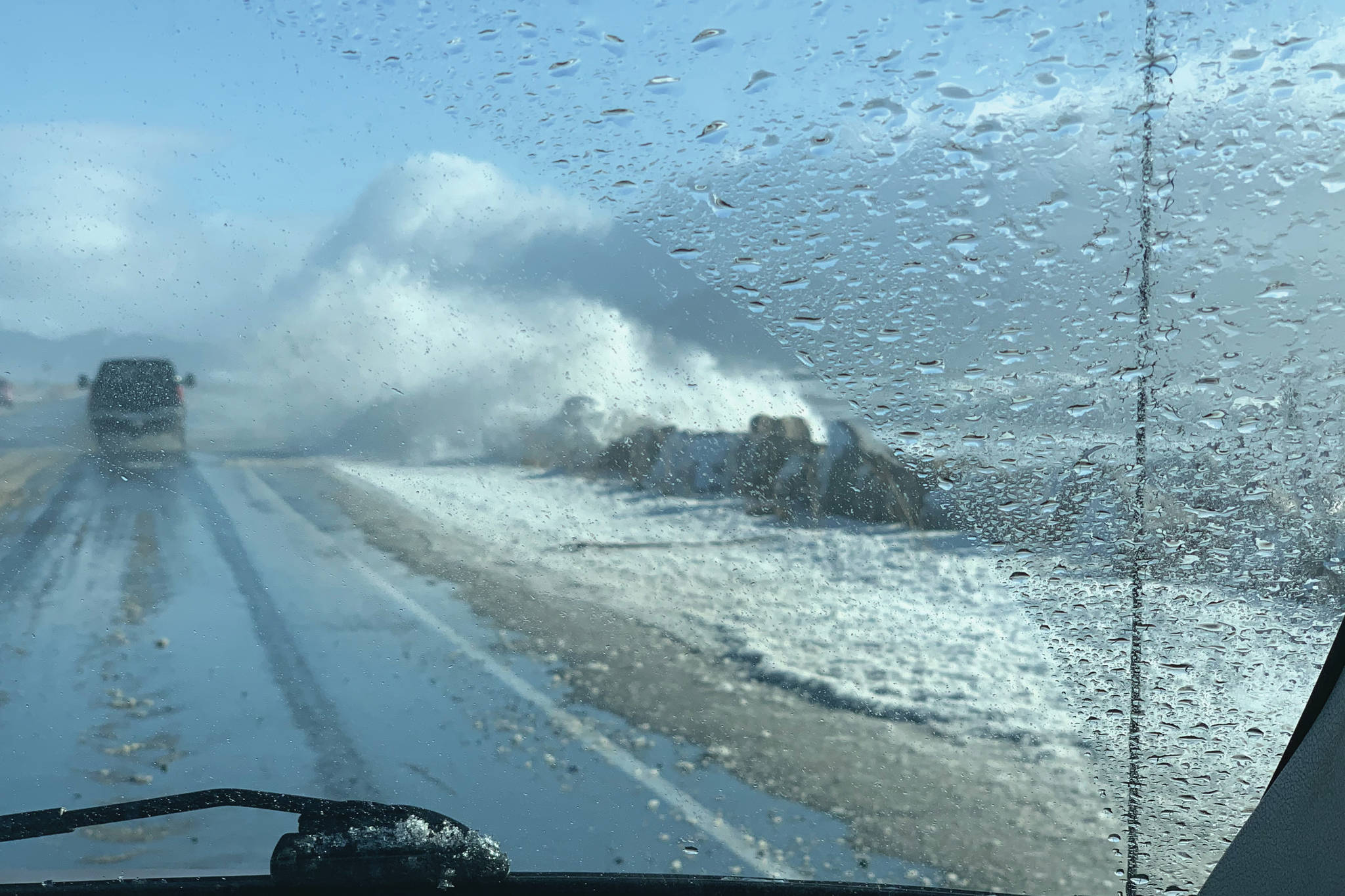 Waves during an extreme high tide and big seas pound the Homer Spit on Sunday afternoon, Feb. 28, 2021, on the Homer Spit, as seen through photographer Malia Anderson's windshield. (Photo by Malia Anderson / Homer News)