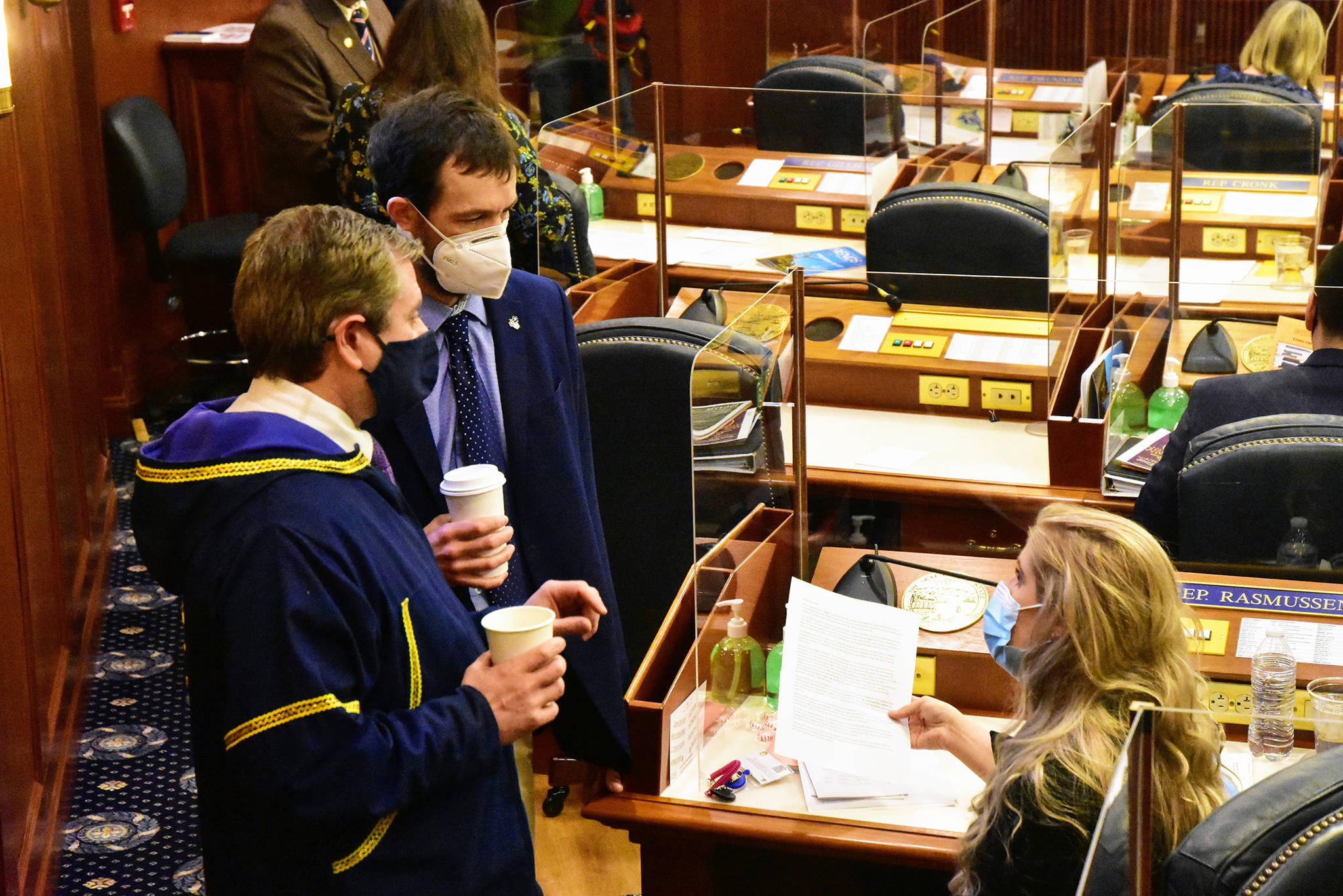 From left to right: Alaska state Reps. Chris Tuck, D-Anchorage, Zack Fields, D-Anchorage, and Sara Rasmussen, R-Anchorage, speak on the Alaska House floor on Friday, March 5, 2021, in Juneau, Alaska. The House passed a so-called Sense of the House on Friday, condemning as inappropriate and objectifying comments Fields had made toward Rasmussen last month. (Peter Segall/The Juneau Empire via AP, Pool)