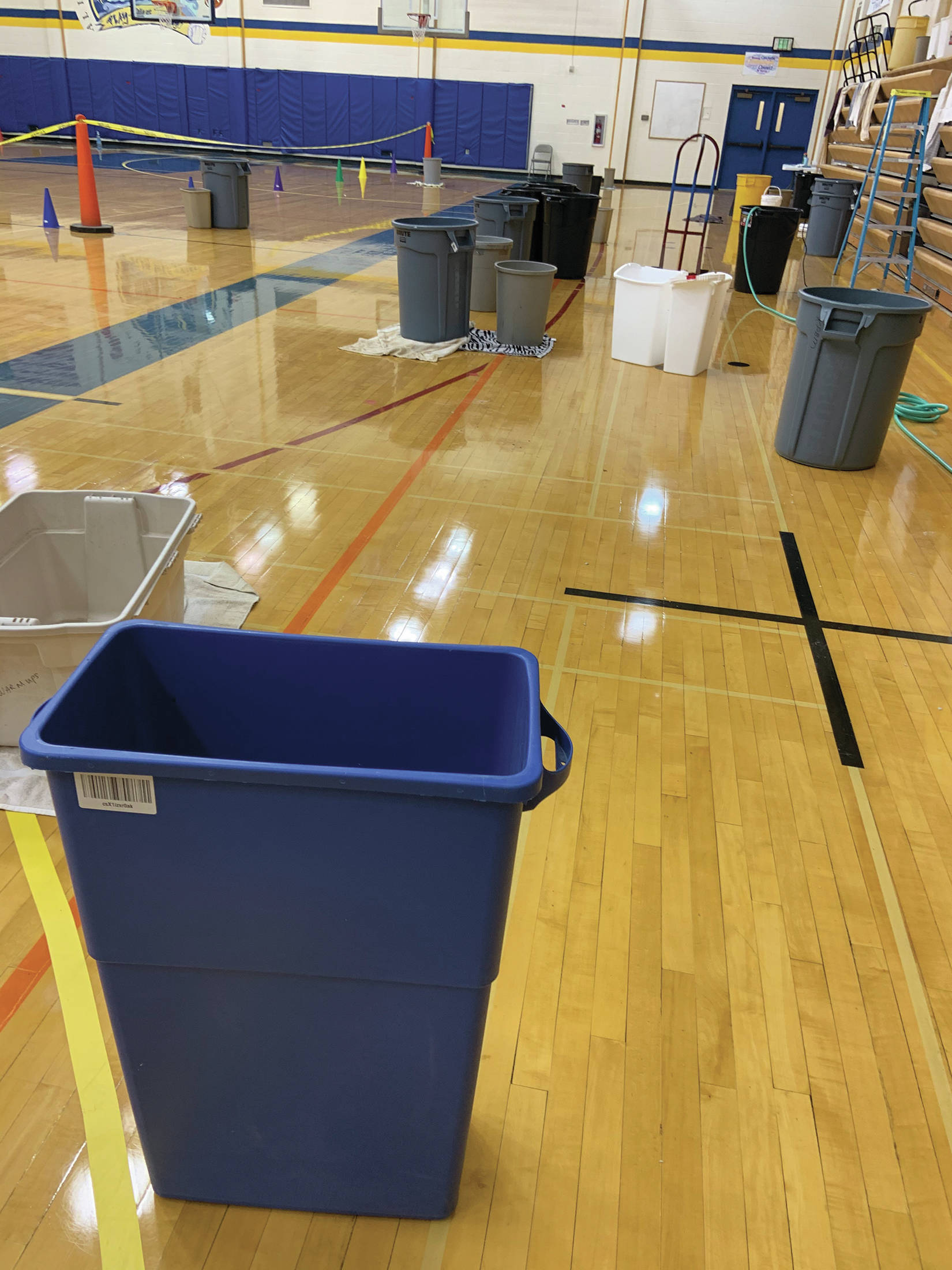 Buckets fill the Homer High School gymnasium, catching water leaking through a portion of the roof at the school in Homer, Alaska. (Photo courtesy Doug Waclawski)