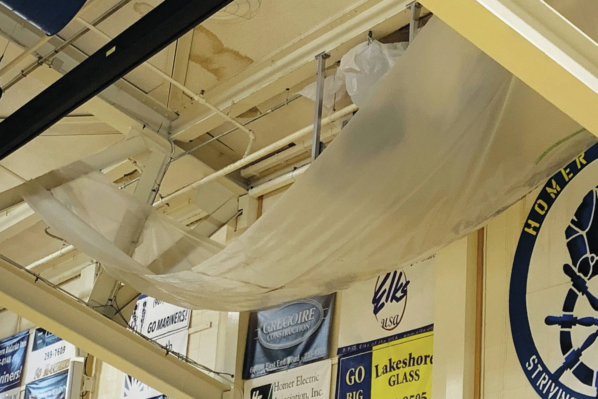 A large tarp hangs in the Homer High School gymnasium to catch water leaking through the roof at the school in Homer, Alaska. (Photo courtesy Doug Waclawski)