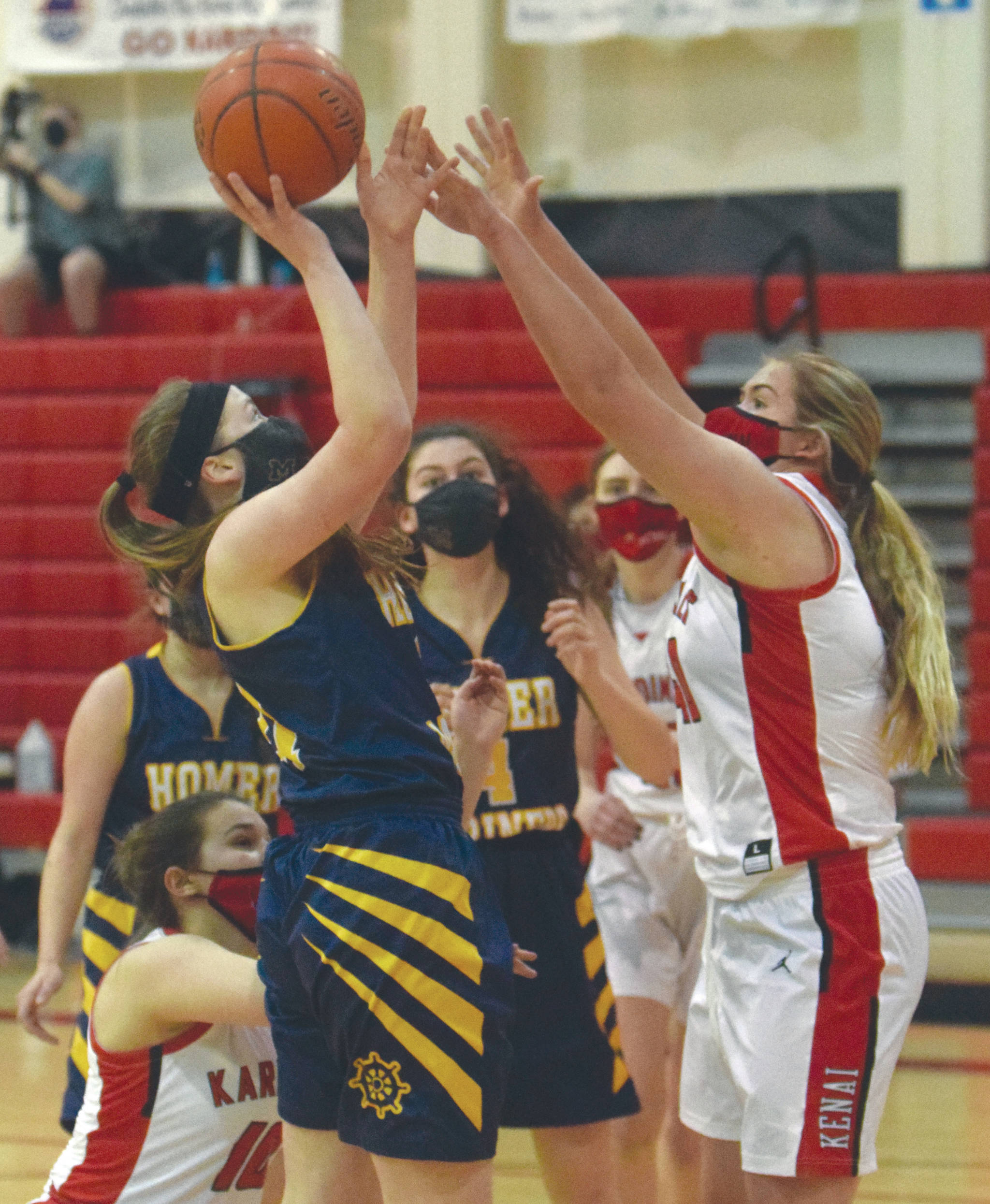 Homer’s Sophie Ellison goes up for a shot against Kenai Central’s Emma Beck on Thursday, March 4, 2021, at Kenai Central High School in Kenai, Alaska. (Photo by Jeff Helminiak/Peninsula Clarion)