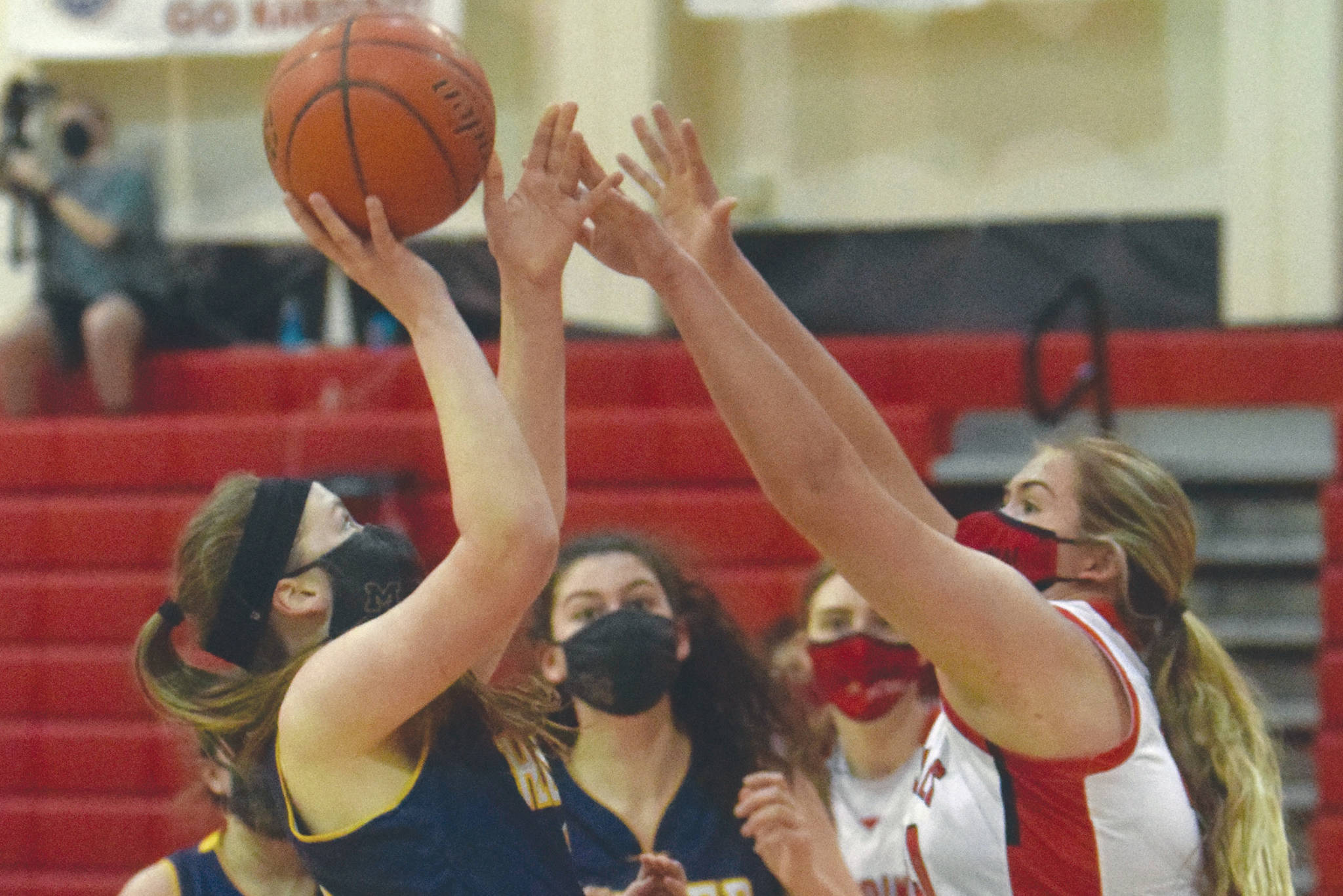 Homer's Sophie Ellison goes up for a shot against Kenai Central's Emma Beck on Thursday, March 4, 2021, at Kenai Central High School in Kenai, Alaska. (Photo by Jeff Helminiak/Peninsula Clarion)