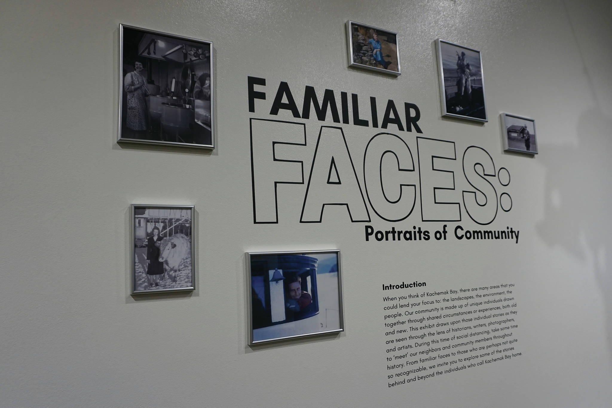 A collage of photographs surrounds the description of “Familiar Faces: Portrait of a Community,” on exhibit through May 2021 at the Pratt Museum in Homer, Alaska. (Photo by Michael Armstrong/Homer News)