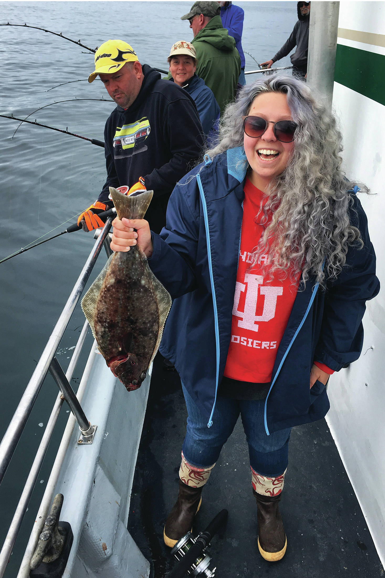 The author laughs at her poor luck at having caught a chicken during a July 2019 charter trip in Kachemak Bay near Homer, Alaska. (Photo courtesy Megan Pacer)