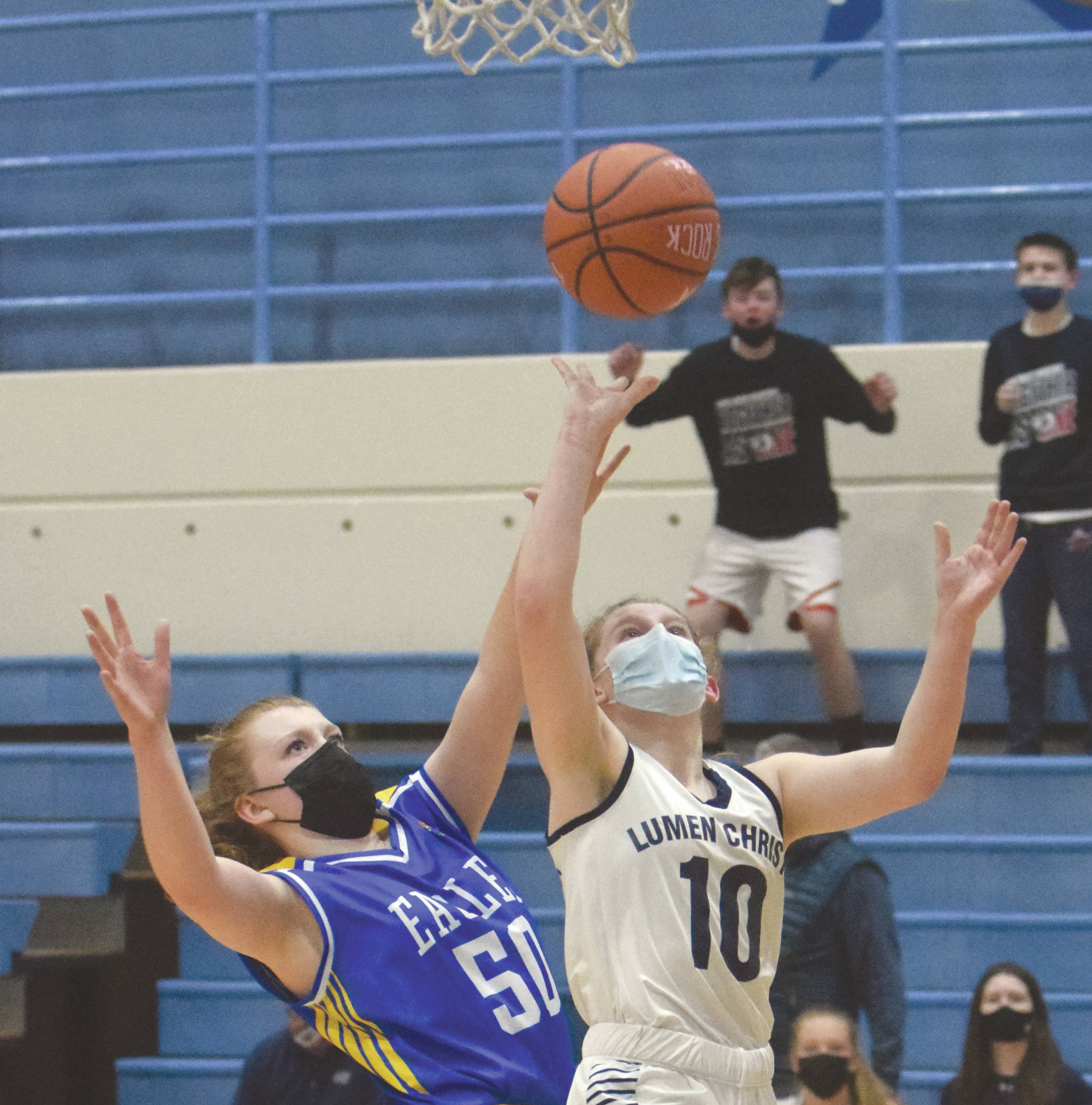 Lumen Christi’s Emily Ross drives to the basket on Cook Inlet Academy’s Hope Hillyer during the Peninsula Conference championship game Friday, March 19, 2021, at Soldotna High School in Soldotna, Alaska. (Photo by Jeff Helminiak/Peninsula Clarion)