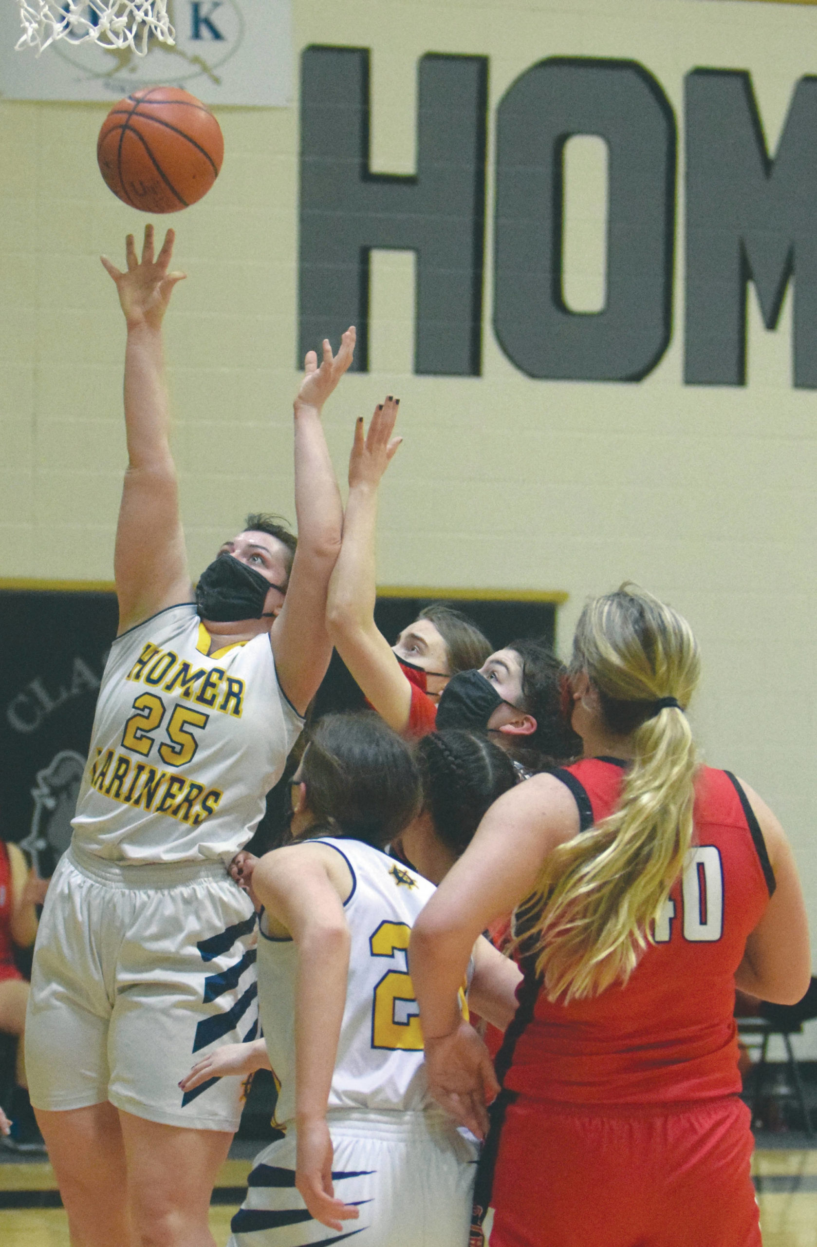 Homer’s Tonda Smude scores against Kenai Central on Friday, March 12, 2021, at the Southcentral Conference tournament at Nikiski High School in Nikiski, Alaska. (Photo by Jeff Helminiak/Peninsula Clarion)