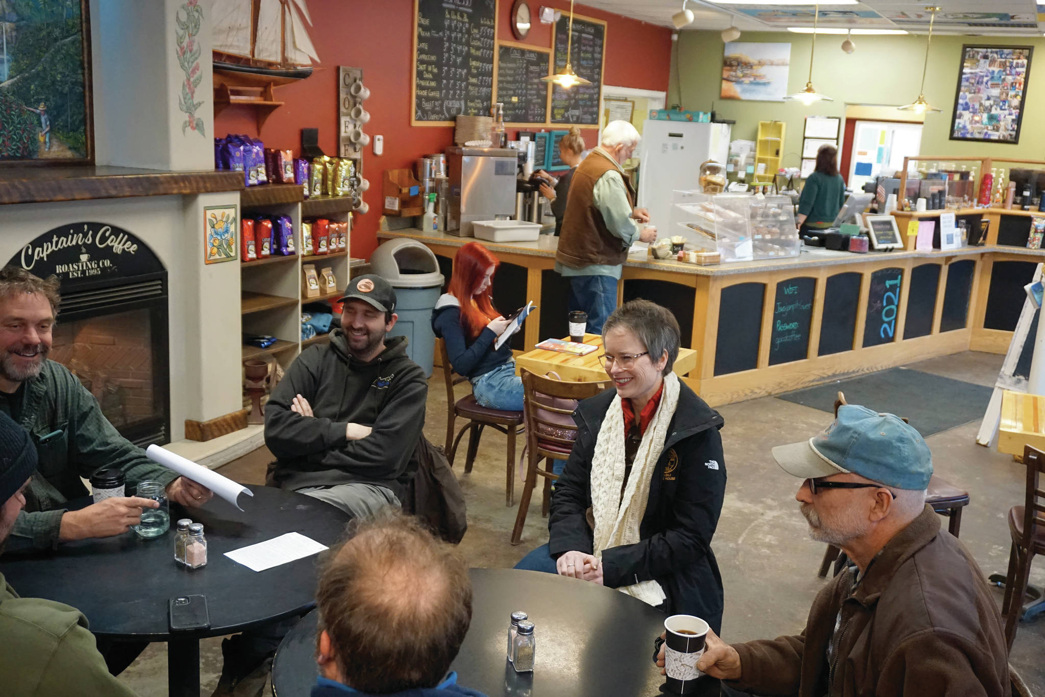Rep. Sarah Vance, R-Homer, second from right, listens to a group of people before holding a town hall meeting on Monday, March 29, 2021, at Captain’s Coffee in Homer, Alaska. (Photo by Michael Armstrong/Homer News)