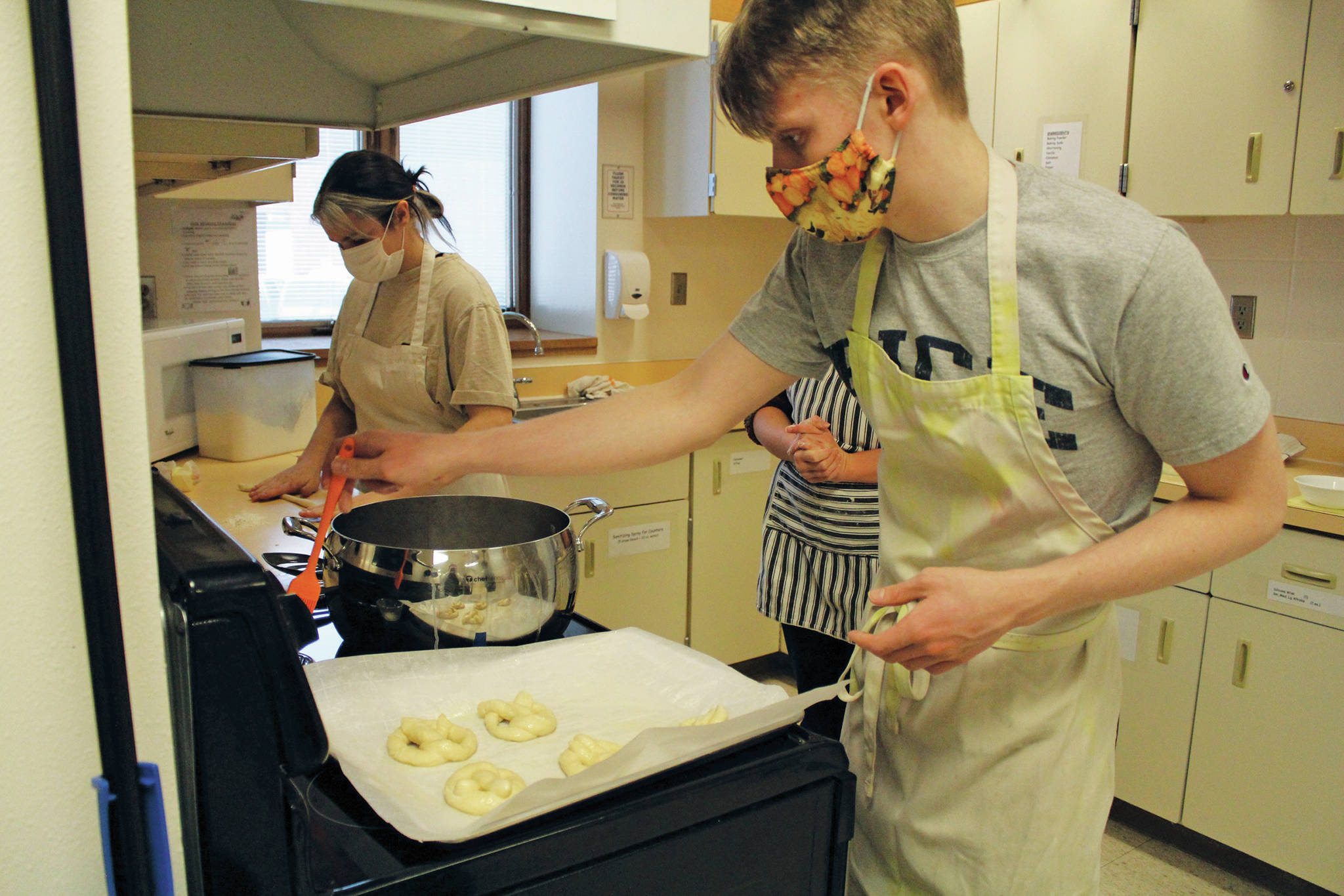 Zoe Adkins (left) and Emmet Wilkinson (right) prepare pretzels in a high school food and nutrition class at Homer High School in Homer, Alaska. (Photo by Katelyn Engebretsen/Homer High Yearbook)