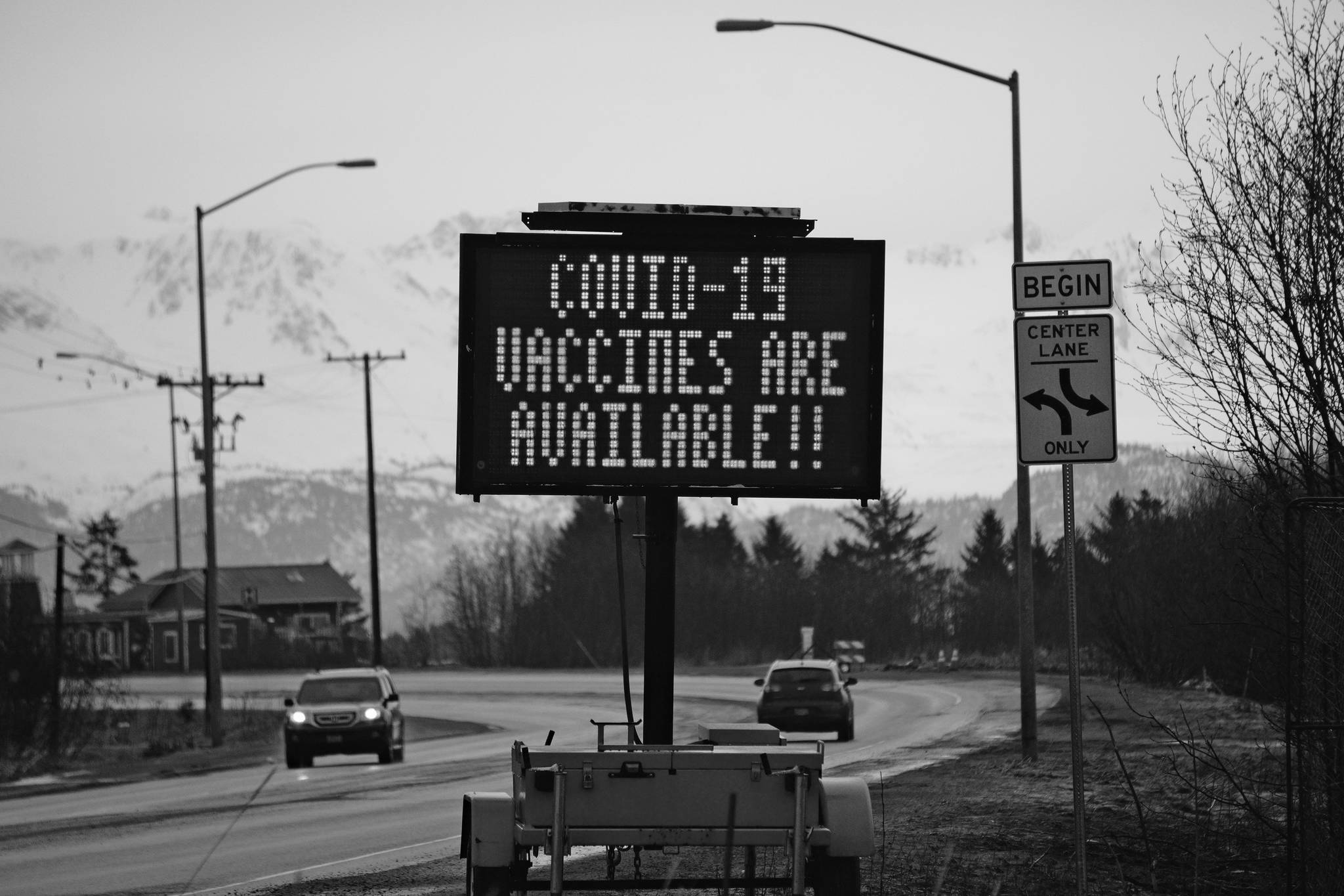 A sign on Tuesday, March 30, 2021, on the Sterling Highway near Soundview Avenue announces the availability of COVID-19 vaccines in Homer, Alaska, . (Photo by Michael Armstrong/Homer News)