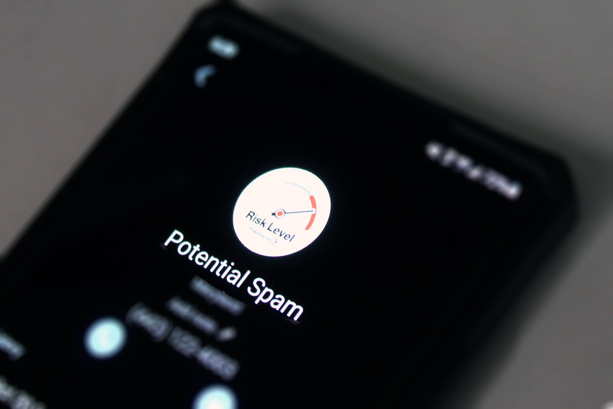 A phone screen displays a message warning of a potential spam call. Juneau Police Department warns residents to be aware of a scam involving someone claiming to be with Social Security Administration. (Ben Hohenstatt / Juneau Empire)