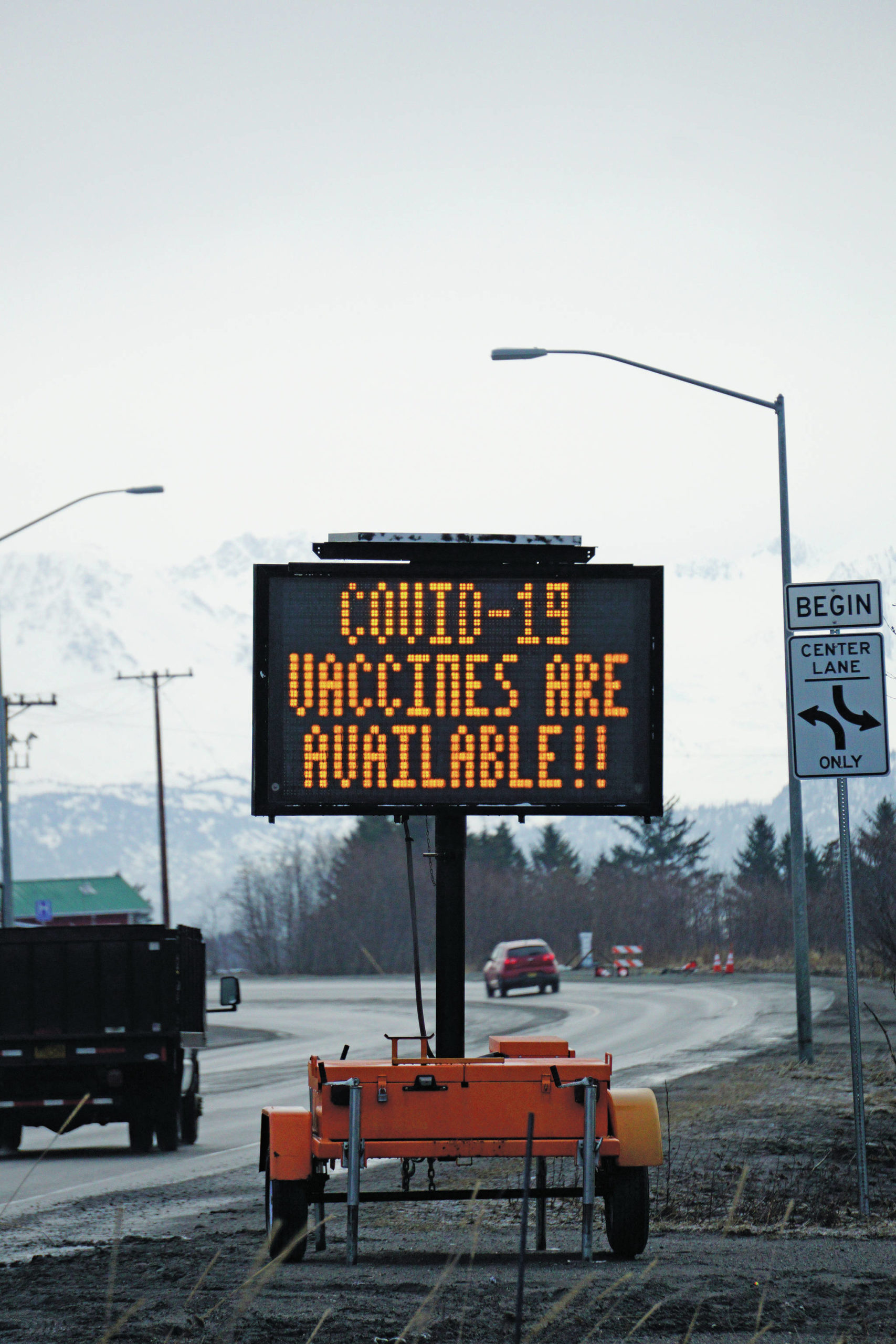 A sign on Tuesday, March 30, 2021, on the Sterling Highway near Soundview Avenue announces the availability of COVID-19 vaccines in Homer, Alaska, . (Photo by Michael Armstrong/Homer News)