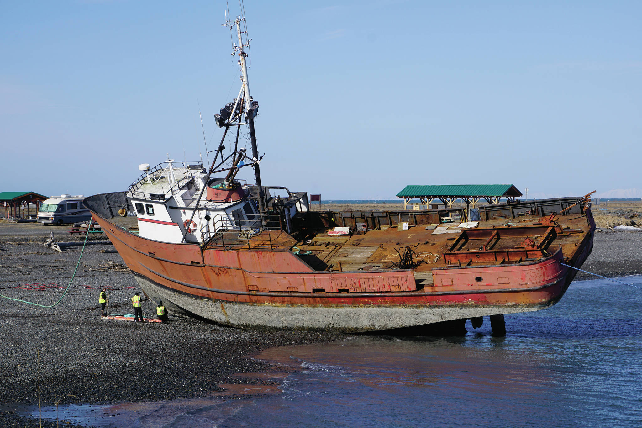 Crews work on a boat on Monday, April 5, 2021, at the large-vessel haul out beach on the Homer Spit near the Pier 1 Theatre in Homer, Alaska. In the off season boats are hauled onshore for repair at the beach near the Nick Dudiak Fishing Lagoon. (Photo by Michael Armstrong/Homer News)