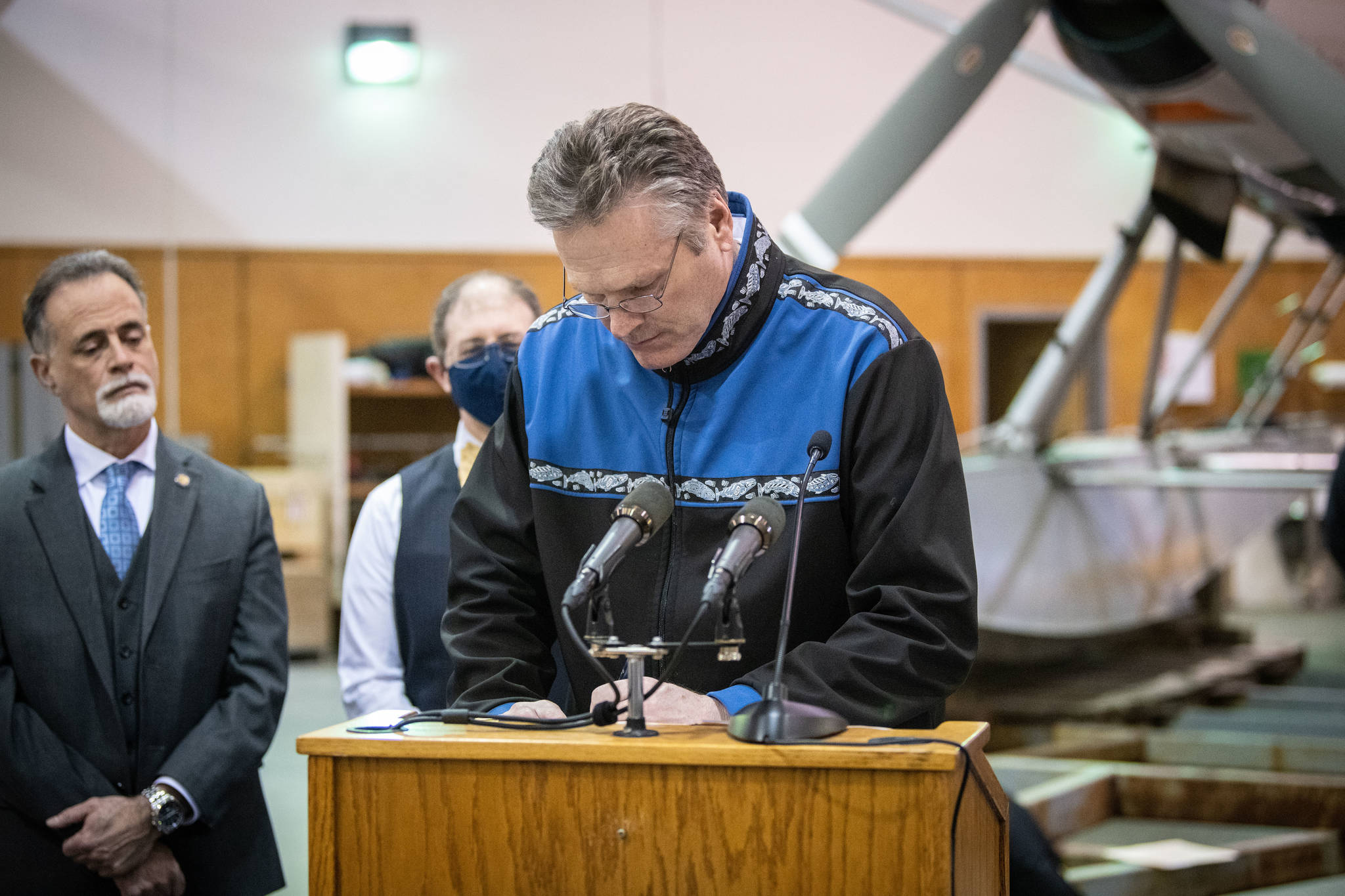 Gov. Mike Dunleavy announces a tourism aid initiative during a press conference on Friday, April 9, 2021, at Wings Airways Hangar in Juneau, Alaska. Dunleavy was joined by officials and business owners, including Alaska Sen. Peter Micciche (left). (Governer’s Office/Kevin Goodman)