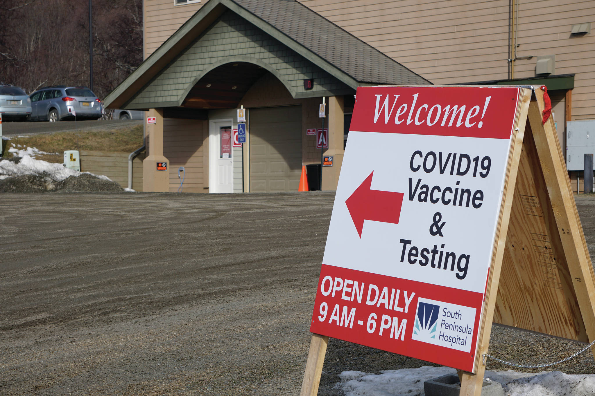 A sign on Friday, April 1, 2021, points the way to COVID-19 vaccines and testing at the South Peninsula Hospital testing and vaccine site on Bartlett Street in Homer, Alaska. (Photo by Michael Armstrong/Homer News)