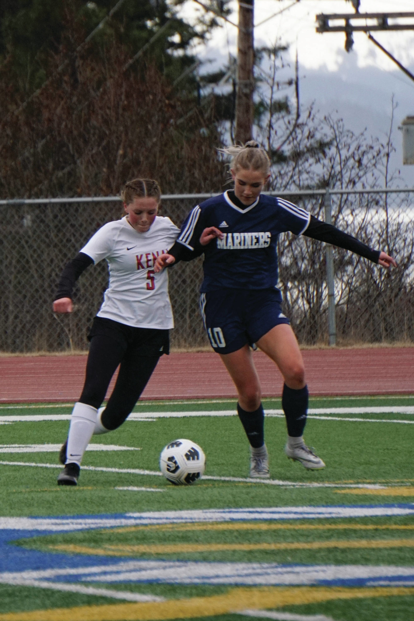Lady Mariner Paige Jones, midfield, defends against Kenai Kardinals No. 5 on Thursday, April 22, 2021, at the Homer High School field in Homer, Alaska. (Photo by Michael Armstrong/Homer News)