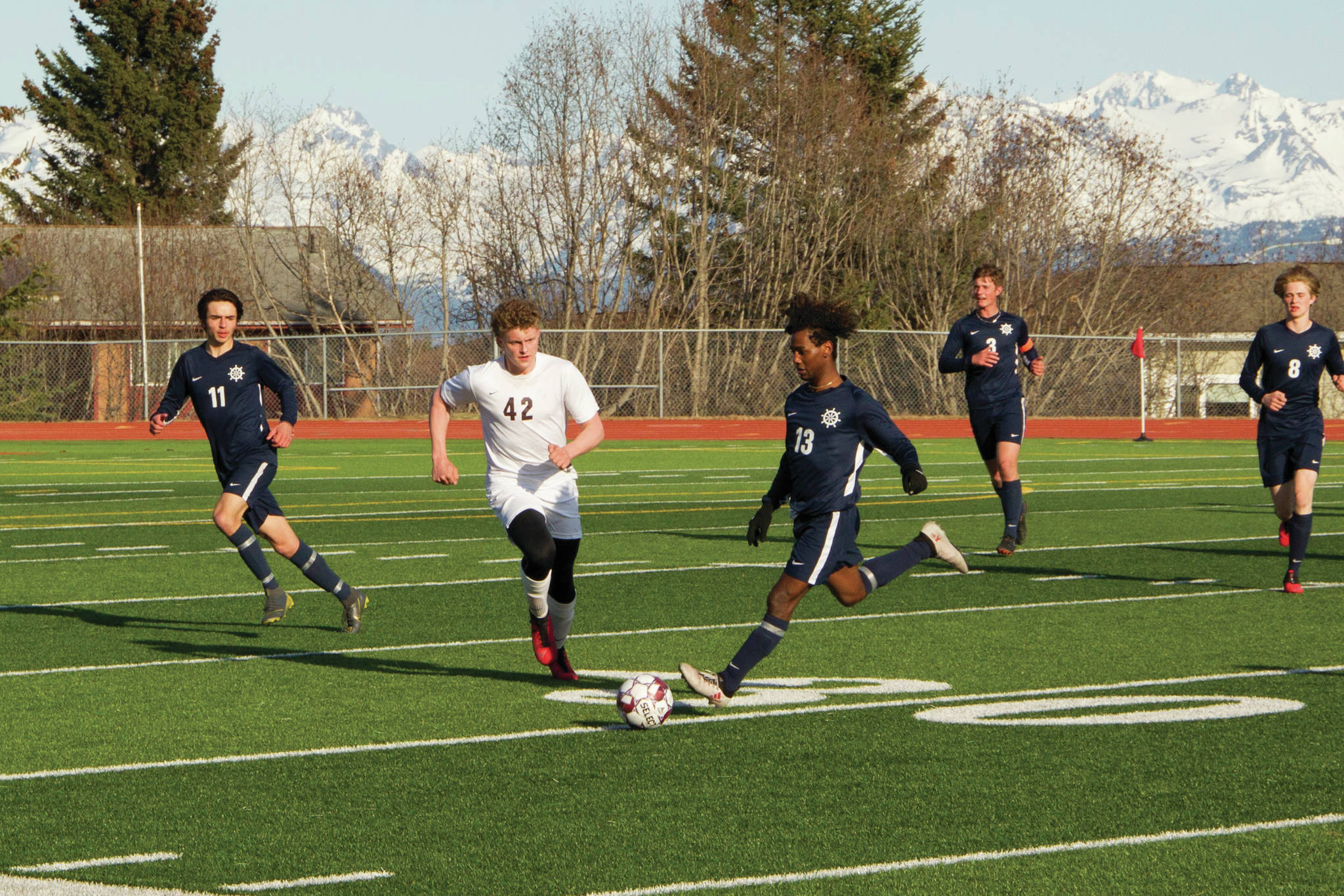 Mariners’ Eyoab Knapp steals the ball from a Grace Christian School player during the soccer game April 30, 2021, at the Homer High School soccer field. (Photo by Sarah Knapp/Homer News)