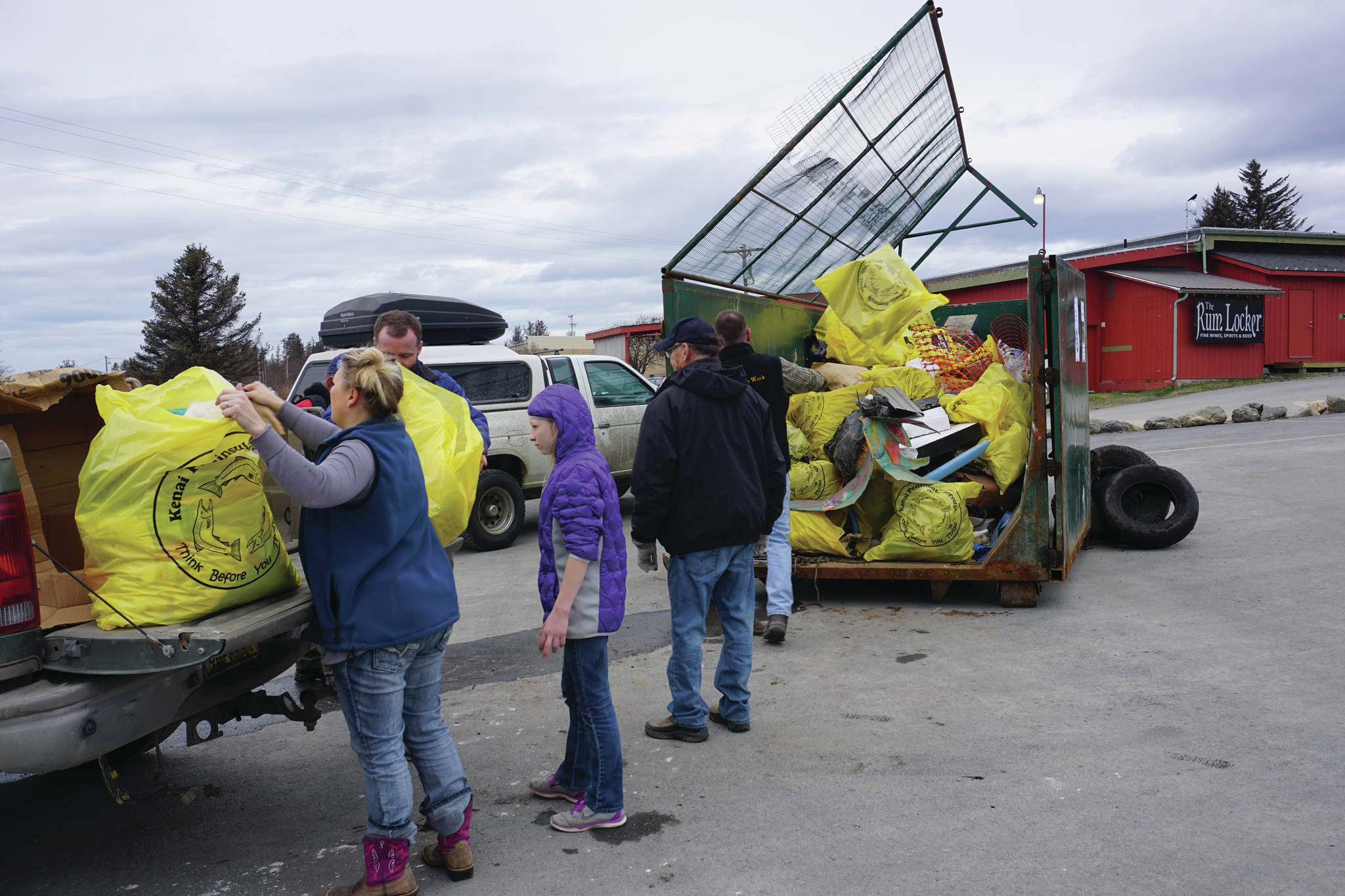 Volunteers unload trash on April 22, 2017, at the Homer Chamber of Commerce and Visitor Center in Homer, Alaska, for that year's clean up day. (Photo by Michael Armstrong/Homer News)