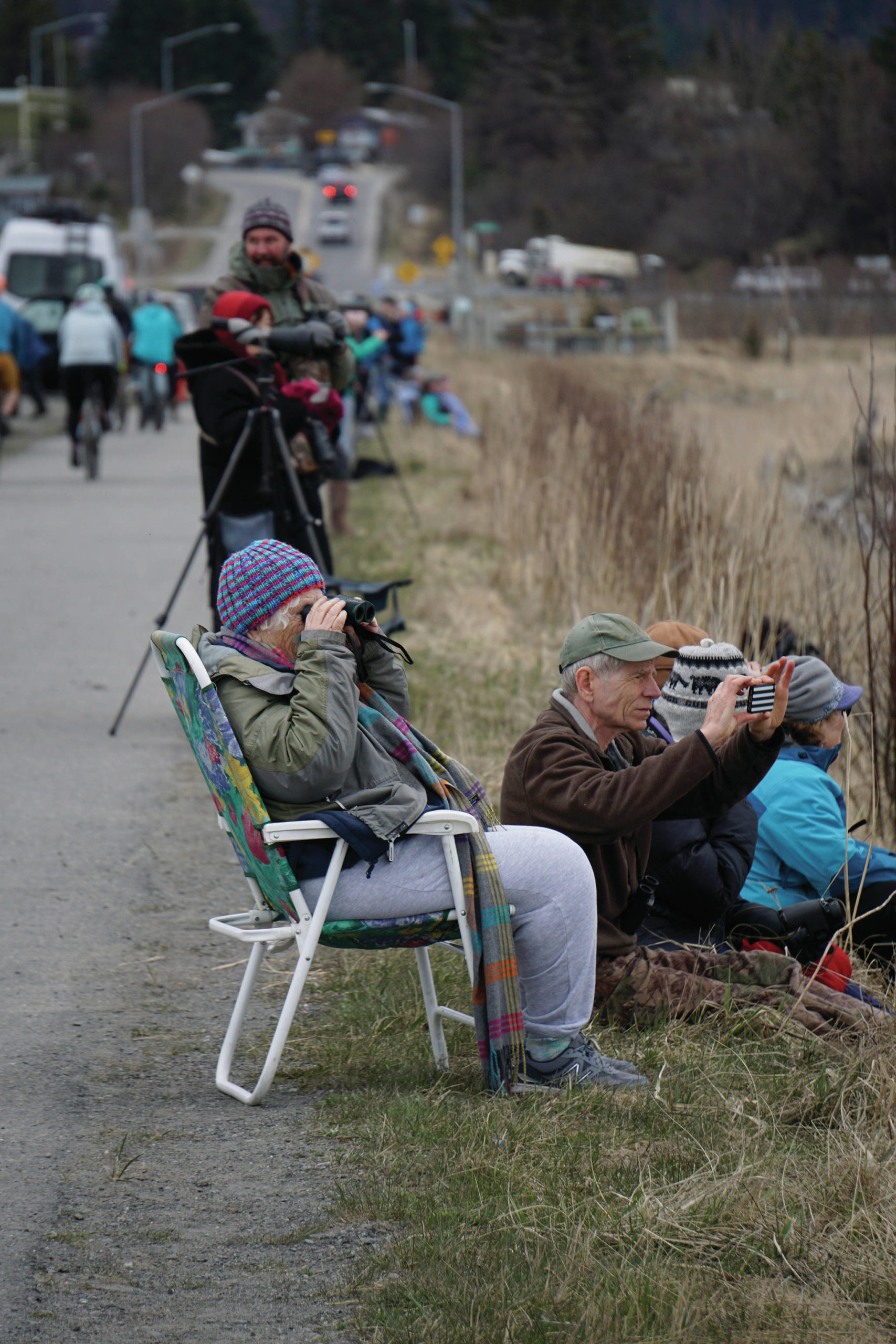 Birders check out shorebirds on the outgoing tide on Saturday, May 8, 2021, at Mud Bay on the Homer Spit in Homer, Alaska. (Photo by Michael Armstrong/Homer News)