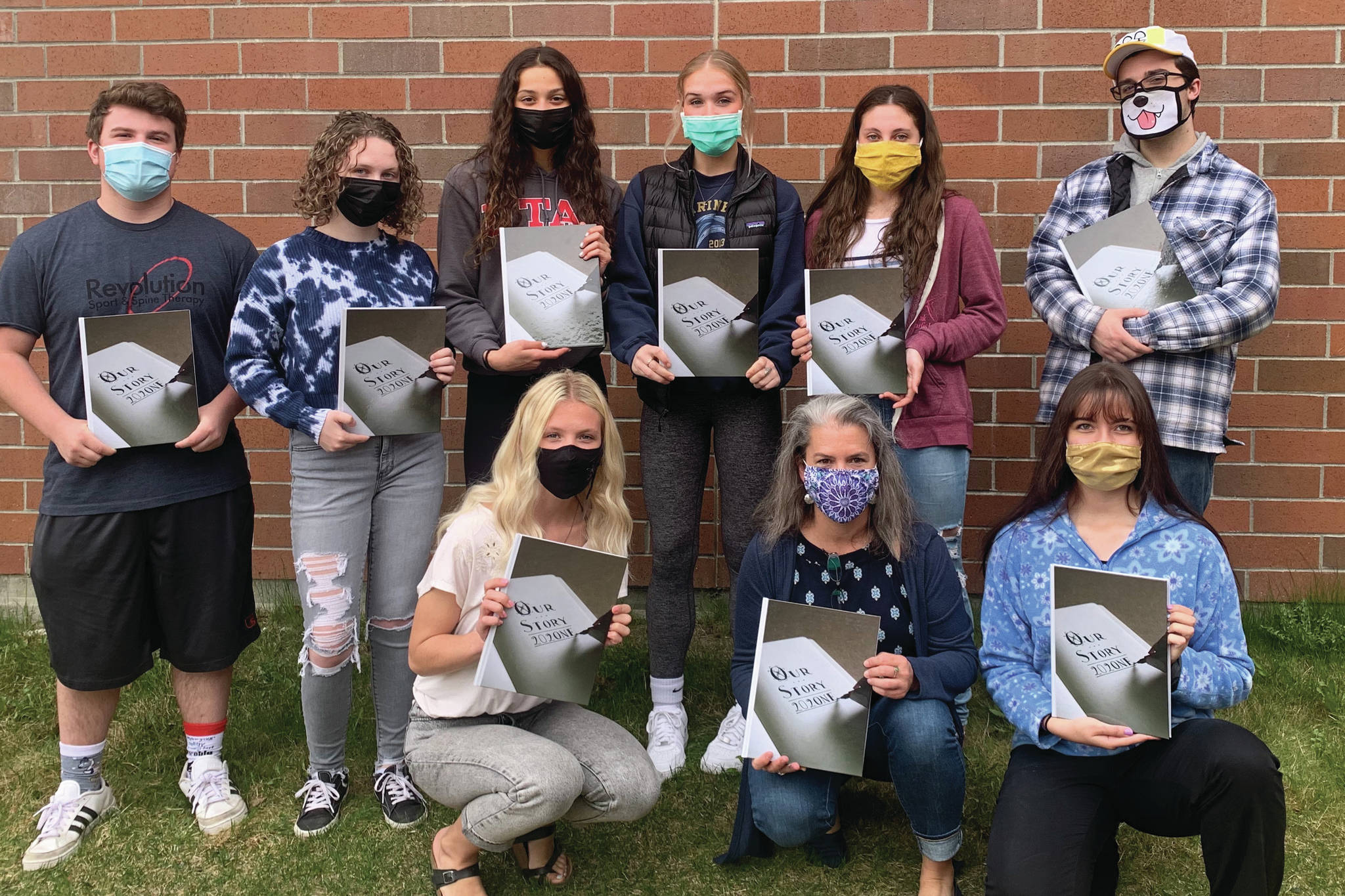 The Homer High School yearbook staff received a Jostens' national award for the 2021 yearbook. The yearbook "Our Story 202One" was credited for its inclusivity and creativity. Pictured is the yearbook staff with the yearbook. Back row left to right: Kamdyn Doughty, Katelyn Engebretsen, Madison Story, Paige Jones, Hannah Hatfield and Tristyn Romeril. Bottom row: Mya Houglum, Suzanne Bishop and Mariah McGuire. Photo submitted by Suzanne Bishop.