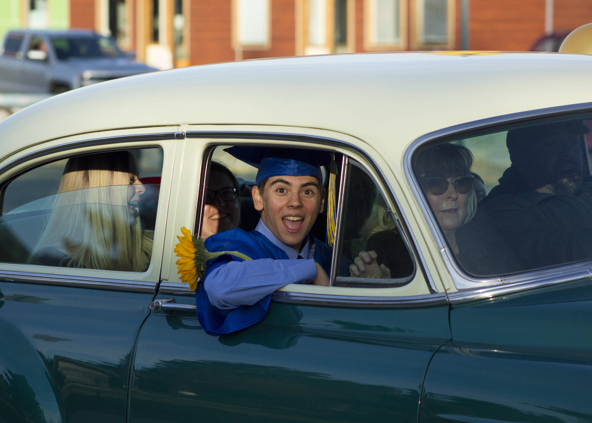 A Homer High School senior celebrates his graduation during the parade through Homer. (Photo by Sarah Knapp/Homer News)