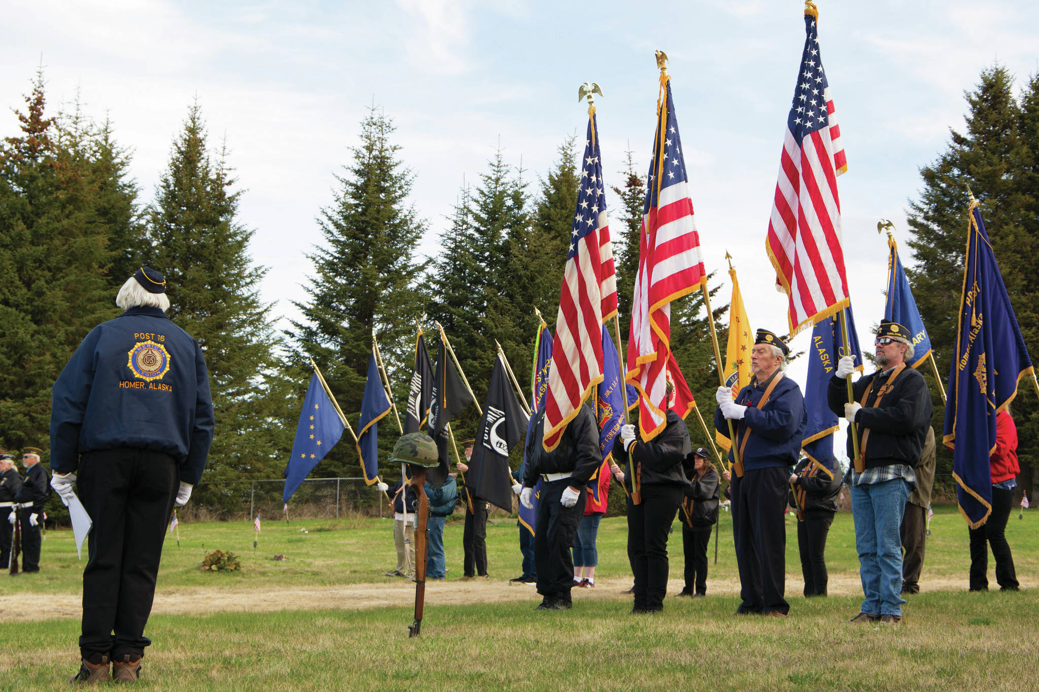 The American Legion Post 16, Homer, American Legion Post 19, Ninilchik, Veterans of Foreign Wars Post 10221, Anchor Point, color guard stands at attention while Taps is played in honor of all servicemen and women who died in service to the United States of America. The veterans organizations hosted the Memorial Day service at Hickerson Memorial Cemetery May 31. (Photo by Sarah Knapp/Homer News)