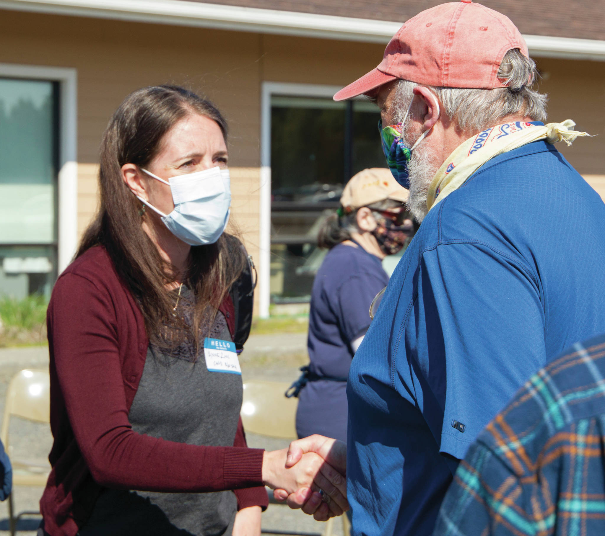 Alaska Chief Medical Officer Anne Zink, M.D., left, meets Homer Mayor Ken Castner, right, at a meet-and-greet on Thursday, May 27, 2021, at the Homer Public Health Center in Homer, Alaska. (Photo by Sarah Knapp/Homer News)
