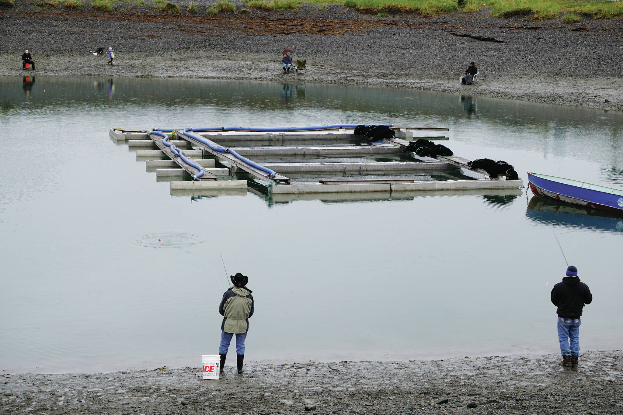 Anglers try their luck at the Nick Dudiak Fishing Lagoon on Saturday, May 29, 2021, on the Homer Spit in Homer, Alaska. The floating pen is for hatchery fish to imprint on the lagoon before being released into Kachemak Bay. (Photo by Michael Armstrong/Homer News)