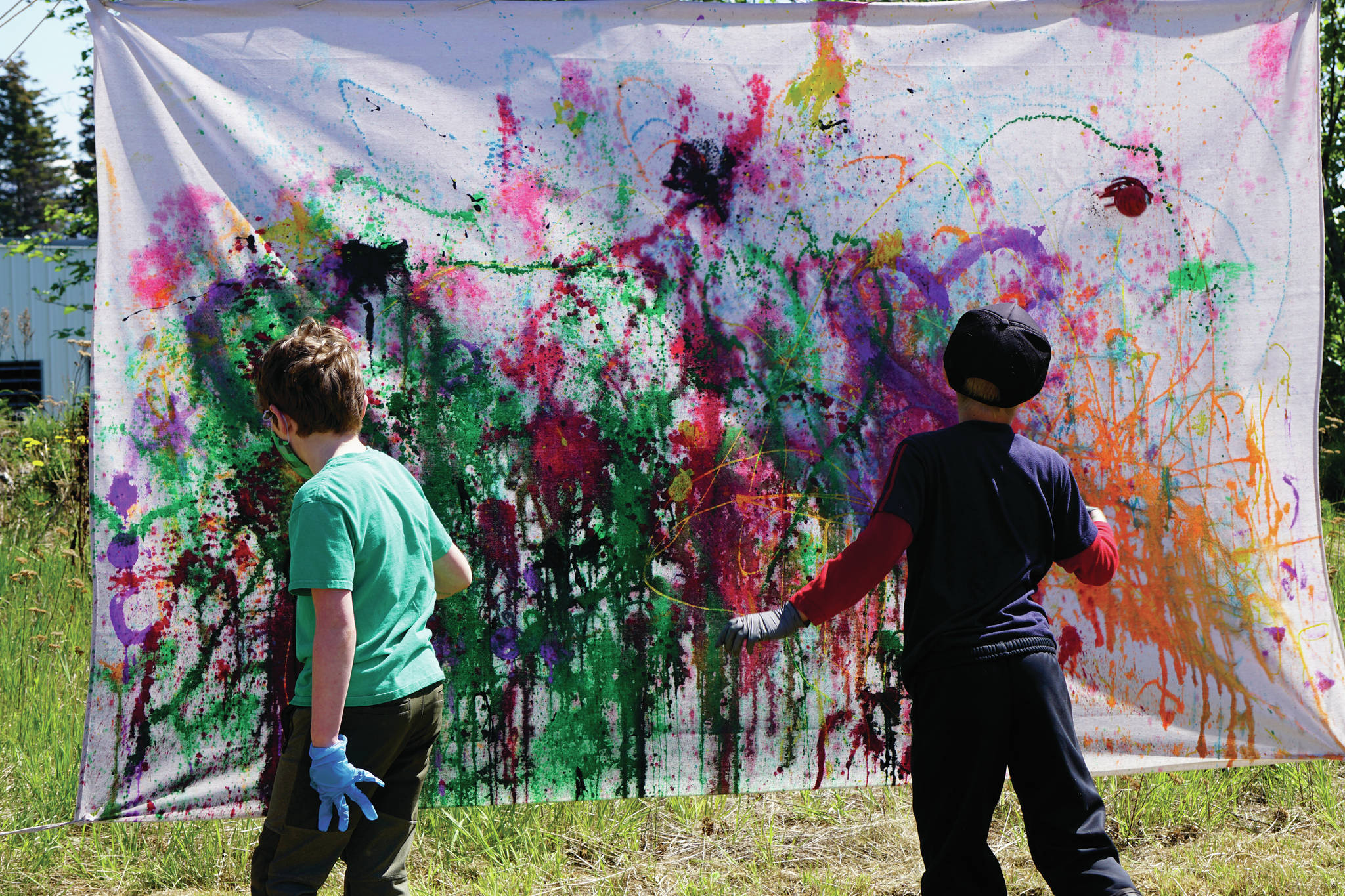 Children help create art with the projectile painting booth on Saturday, June 5, 2021, for Mary Epperson Day at the Homer Council on the Arts in Homer, Alaska. (Photo by Michael Armstrong/Homer News0