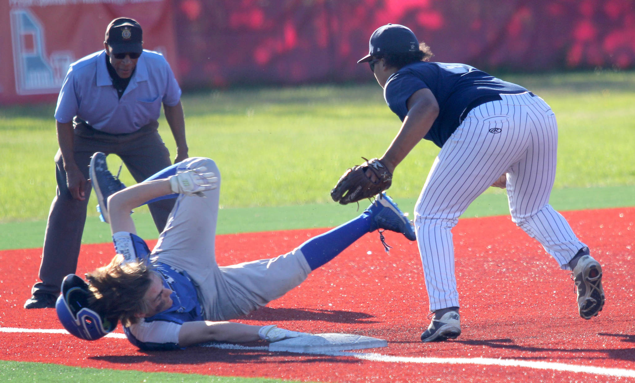 Soldotna third baseman Atticus Gibson gets the tag before Palmer’s Dylan Garrettson slides into third during Palmer’s 7-1 win over the Stars in the Division II state semifinals Friday, June 4, 2021, at Wasilla High School in Wasilla, Alaska. (Photo by Jeremiah Bartz/Frontiersman)
