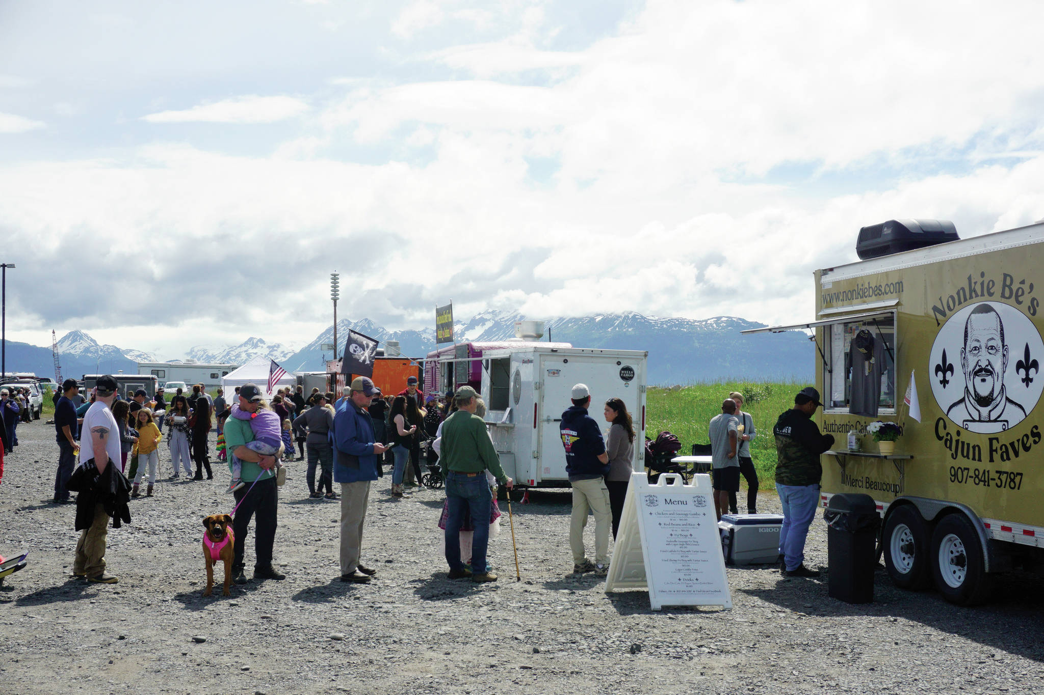 People line up at food trucks and trailers on Saturday, June 19, 2021, at the Kevin Bell Ice Arena parking lot on the Homer Spit in Homer, Alaska. Part of the Homer Chamber of Commerce and Visitor Center’s Food Fest last week, the two-day food truck event drew a steady crowd. (Photo by Michael Armstrong/Homer News)