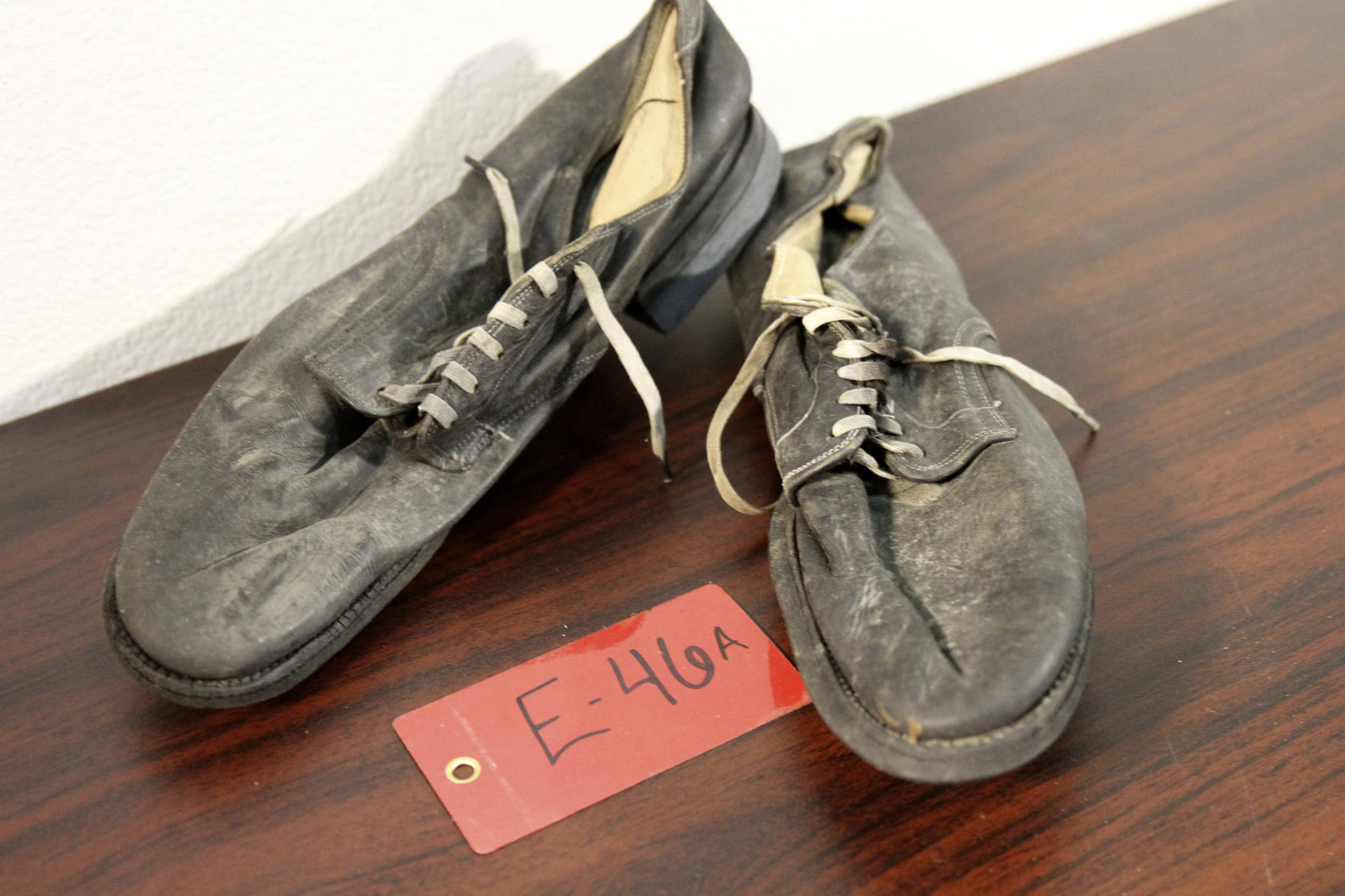 A pair of shoes recovered from the 1952 crash of a C-124 Globemaster were found this month on Colony Glacier and displayed at Joint Base Elmendorf-Richardson, Alaska, Tuesday, Sept. 29, 2021. The plane slammed into a mountain, killing 52 on board, and the plane and its crew have since become part of the glacier. The military has conducted annual summer recovery efforts, finding human remains and personal items on the glacier. (AP Photo/Mark Thiessen)