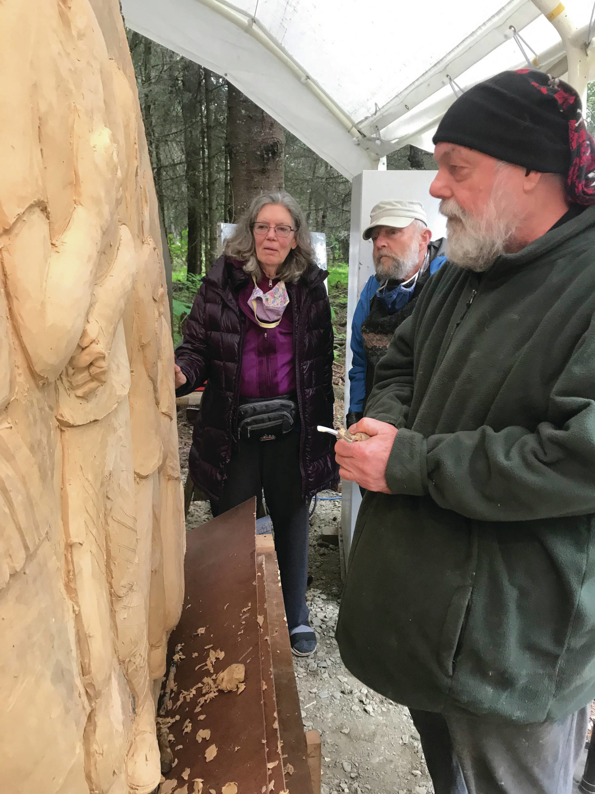 Sara Berg, left, and Ed Berg, center, talk with artist Brad Hughes, right at Hughes’ Homer, Alaska, studio in June 2021 about the Loved & Lost Memorial Bench project Berg and other family and friends of Anesha Murnane commissioned to honor Murnane and other missing woman and children. (Photo by Christina Whiting)