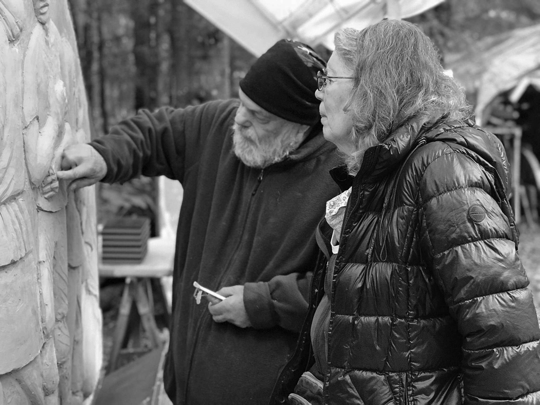 Photo by Christina Whiting 
Sara Berg, right, talks with artist Brad Hughes, left, at Hughes’ Homer studio in June 2021 about the Loved & Lost Memorial Bench project Berg and other family and friends of Anesha Murnane commissioned to honor Murnane and other missing women and children.