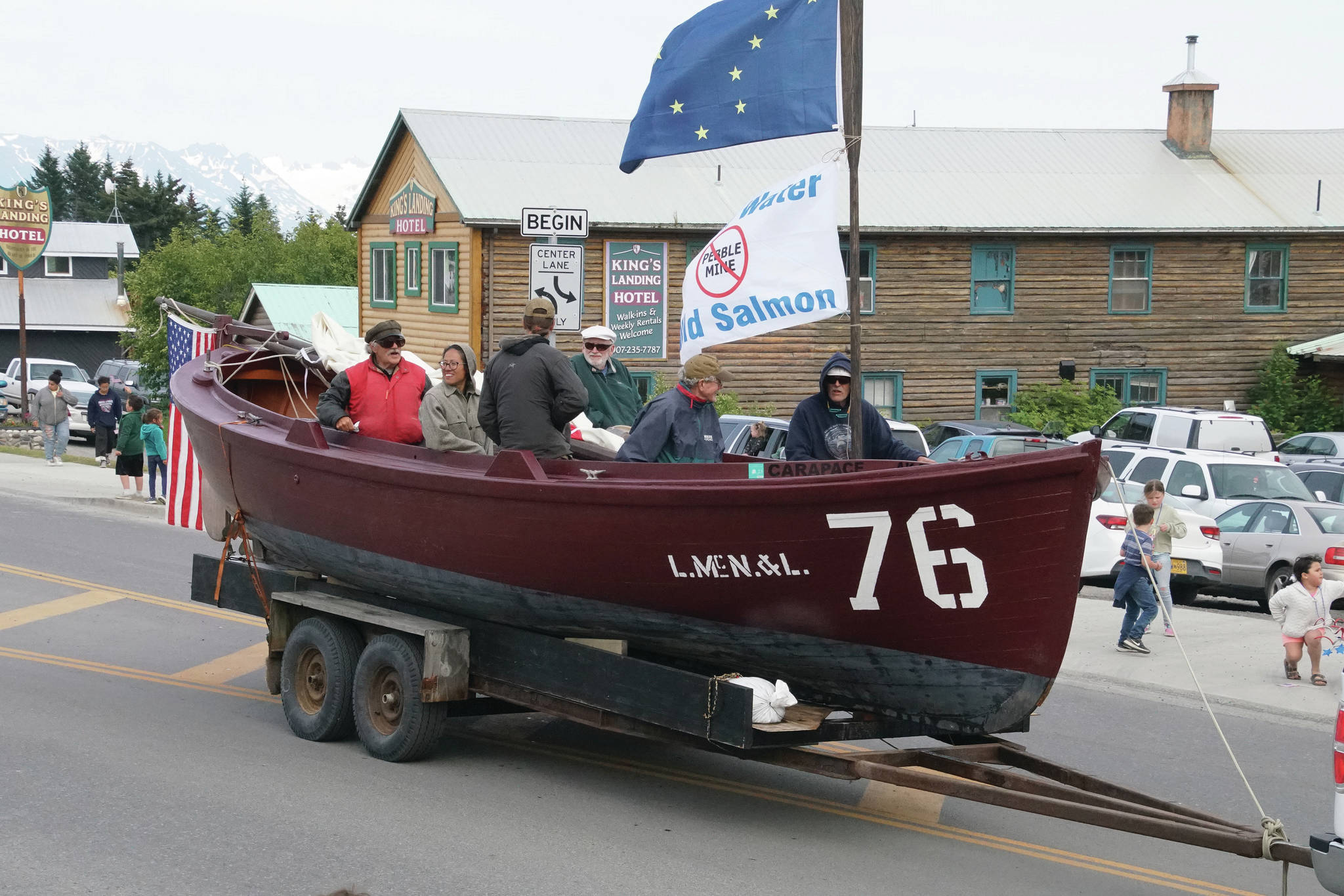 No. 76, along with Tim Troll, center, Dave Seaman, right, and friends, sails down Pioneer Avenue in Homer’s Fourth of July parade on July 4, 2021, in Homer, Alaska. (Photo by Ben Mitchell)