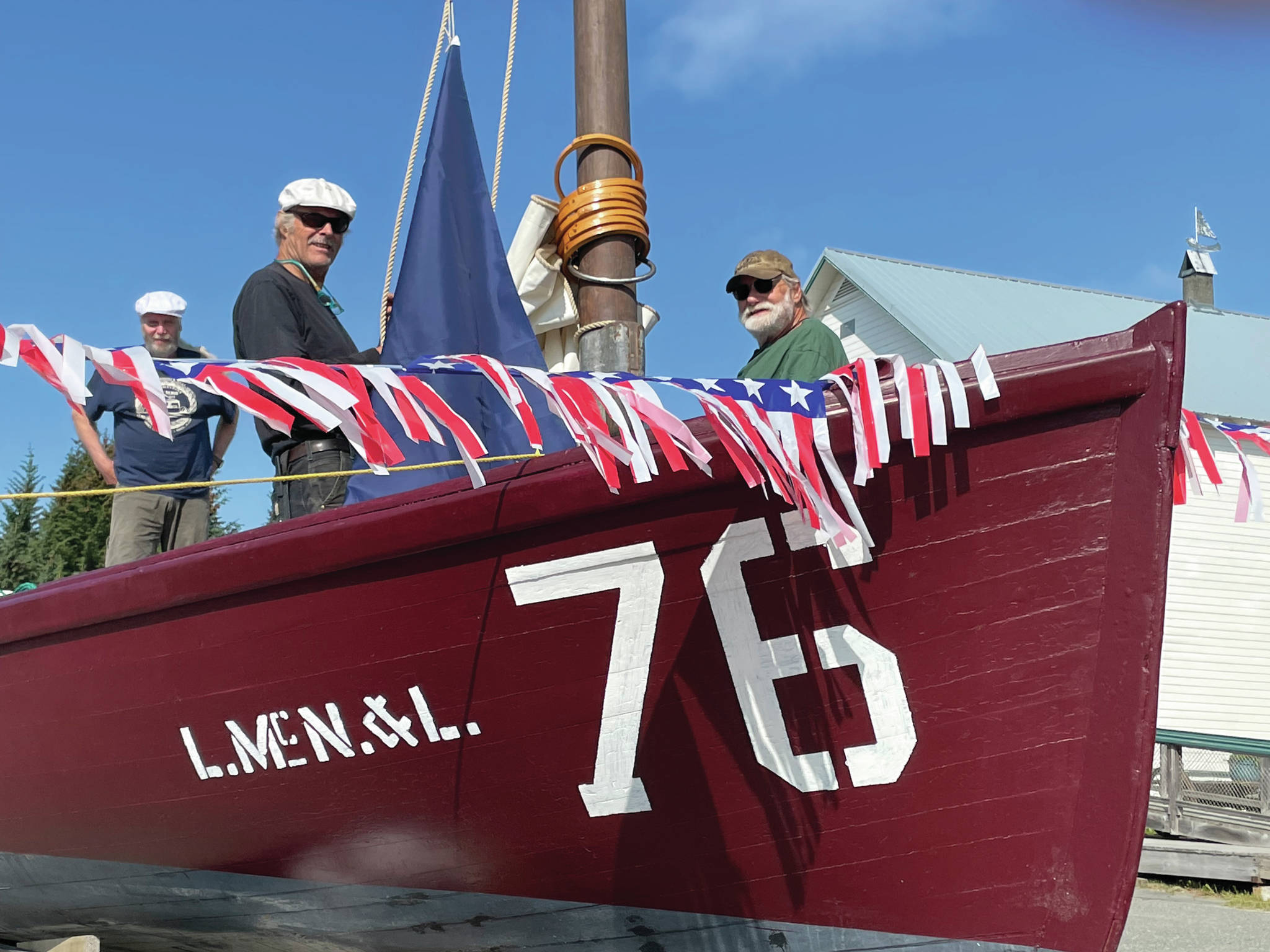 Dave Collette-Paule, left, Dave Seaman, center, and Mike Kennedy, right ready No. 76 for Homer’s Fourth of July Parade on Sunday, July 4, 2021, in Homer, Alaska. (Photo by McKibben Jackinsky)