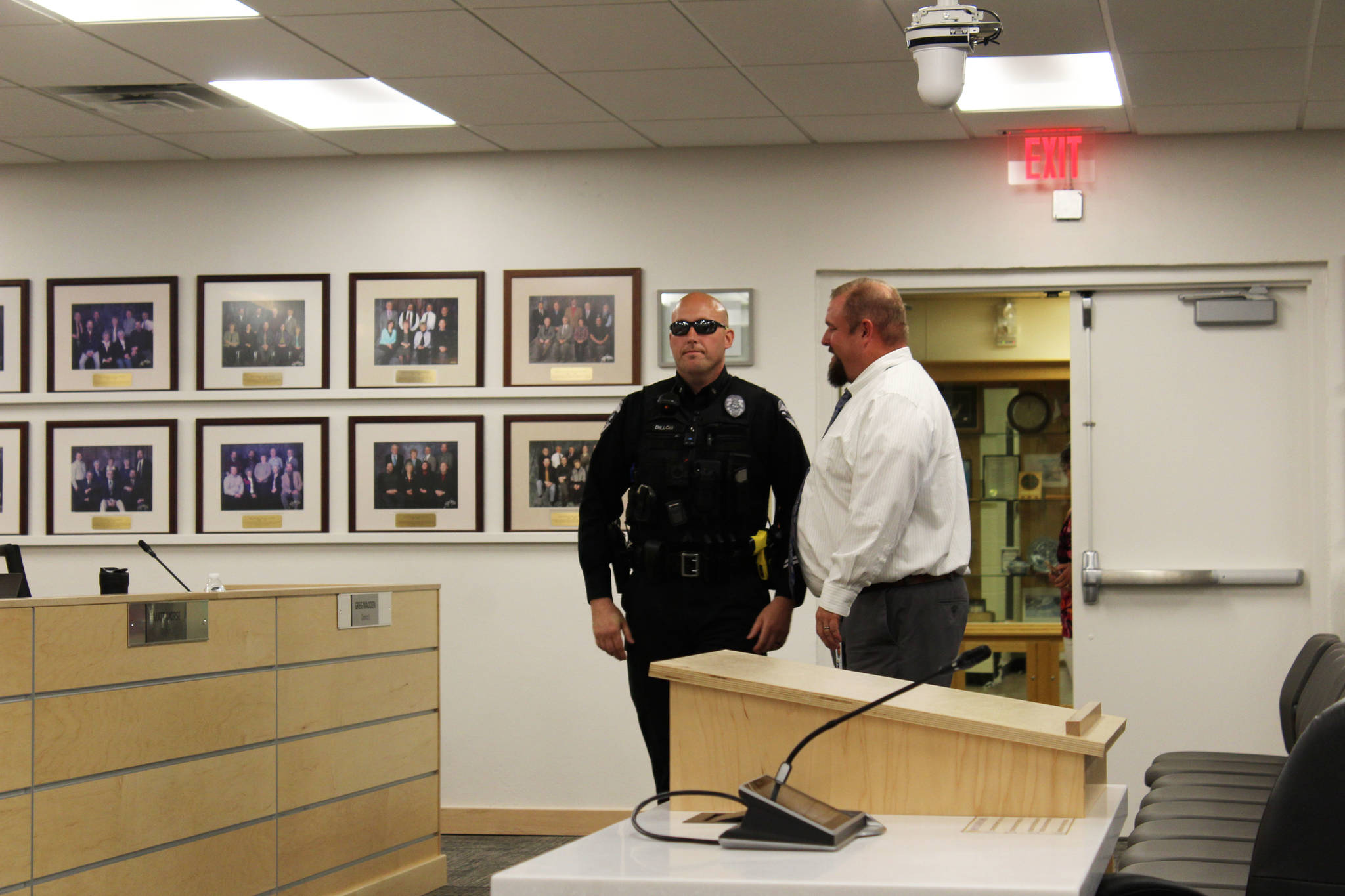 Soldotna Police Department Officer Victor Dillon speaks with KPBSD Director of Secondary Education Tony Graham at the George A. Navarre Borough Admin building on Monday, August 2, 2021 in Soldotna, Alaska. (Ashlyn O'Hara/Peninsula Clarion)
