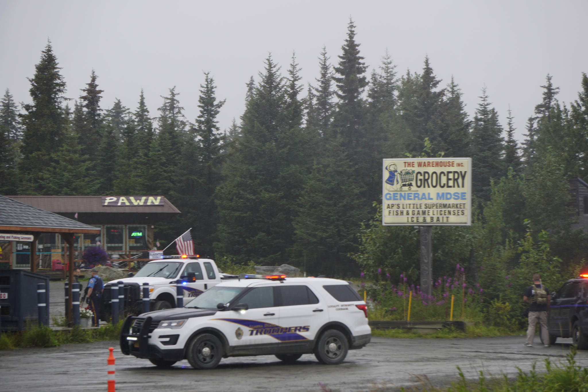 Photo by Michael Armstrong/Homer News 
Alaska State Troopers investigate a shooting scene on Monday, Aug. 23, 2021, at the Anchor Point Warehouse in Anchor Point, Alaska at the store on the Sterling Highway in which an Alaska State Trooper was shot. Troopers were searching for the alleged shooter, Bret Herrick, 60.