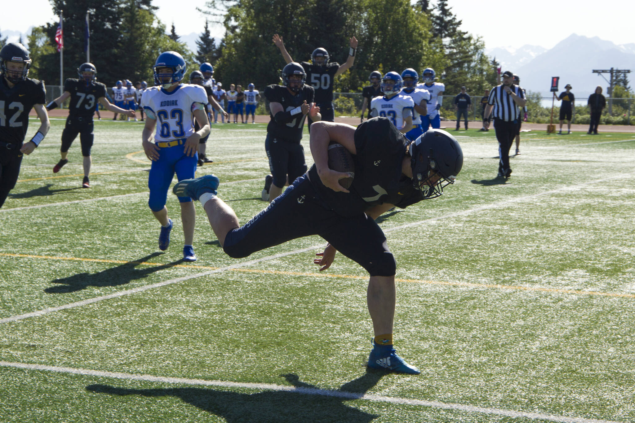 Carter Tennison scores a touchdown for the Homer Mariners against Kodiak High School on Saturday, Aug.28. The Mariners won 34-0. (Photo by Sarah Knapp/Homer News)