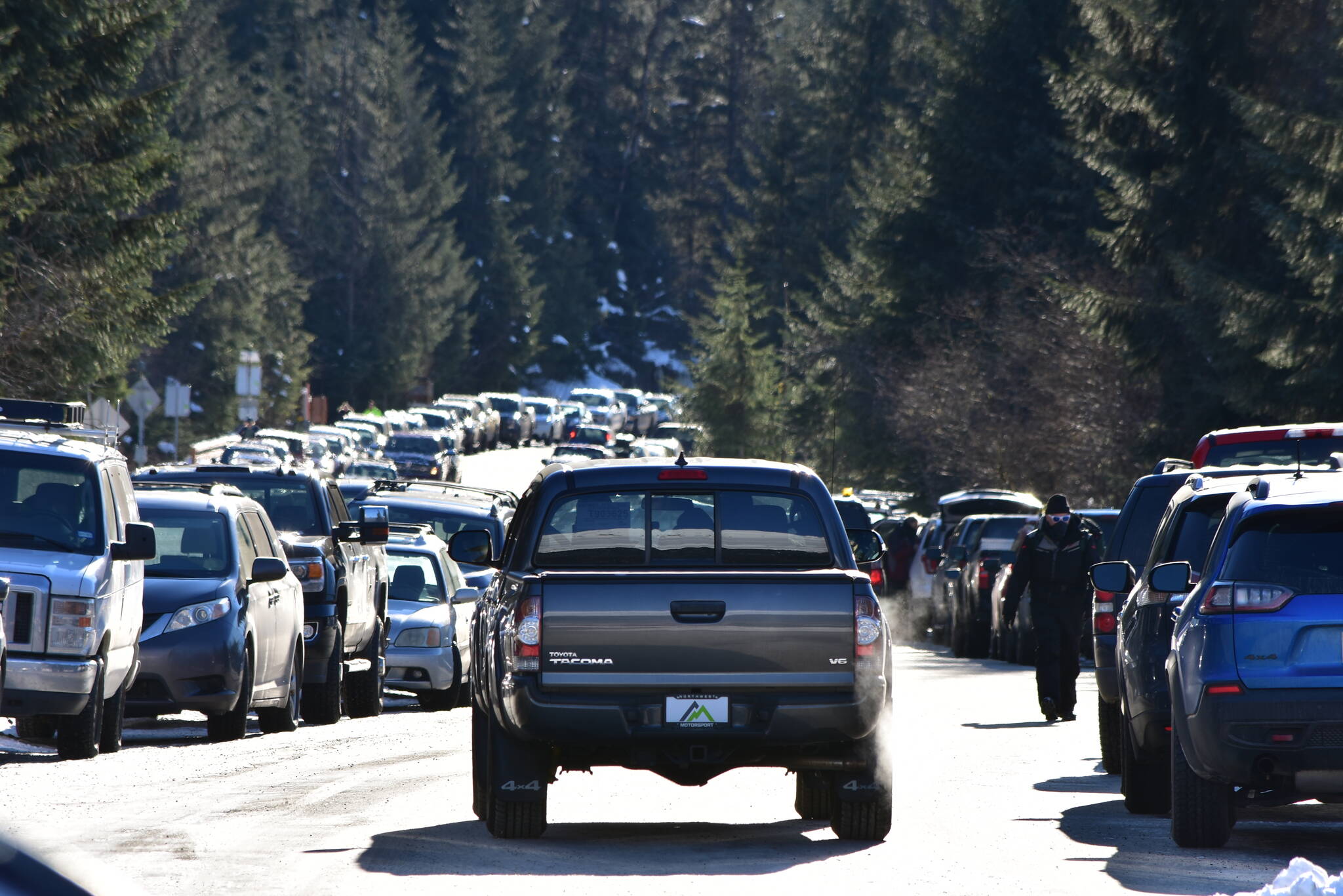 Peter Segall / Juneau Empire File
This photo shows cars parked at the Mendenhall Glacier Visitor Center on Feb. 13, 2021. A local insurance agent says that a recent study claiming women in Alaska pay more for car insurance than men doesn’t reflect his experience.