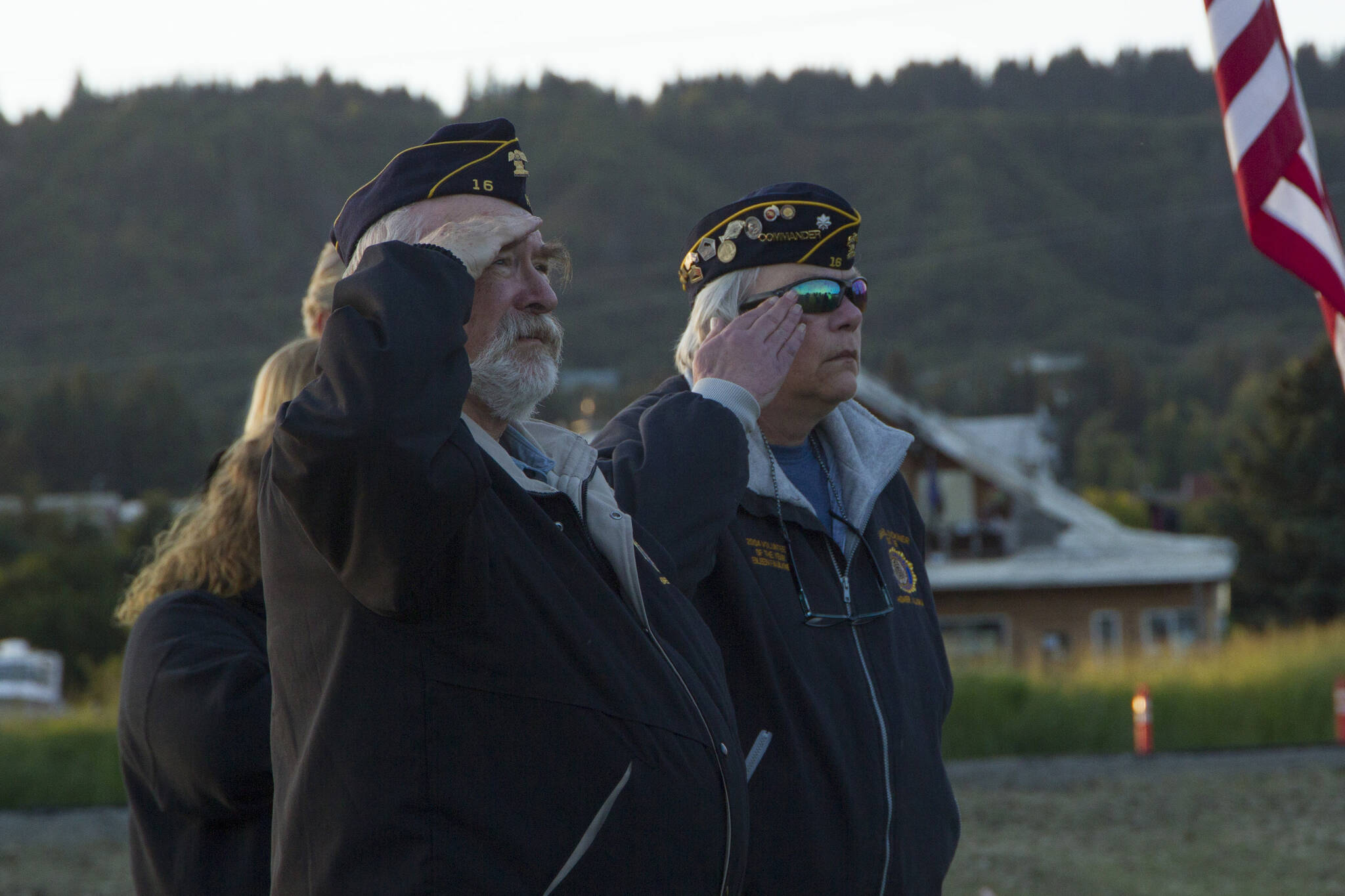 Members of the American Legion Post 16 salute the American flag while “Taps” is played. (Photo by Sarah Knapp/Homer News)