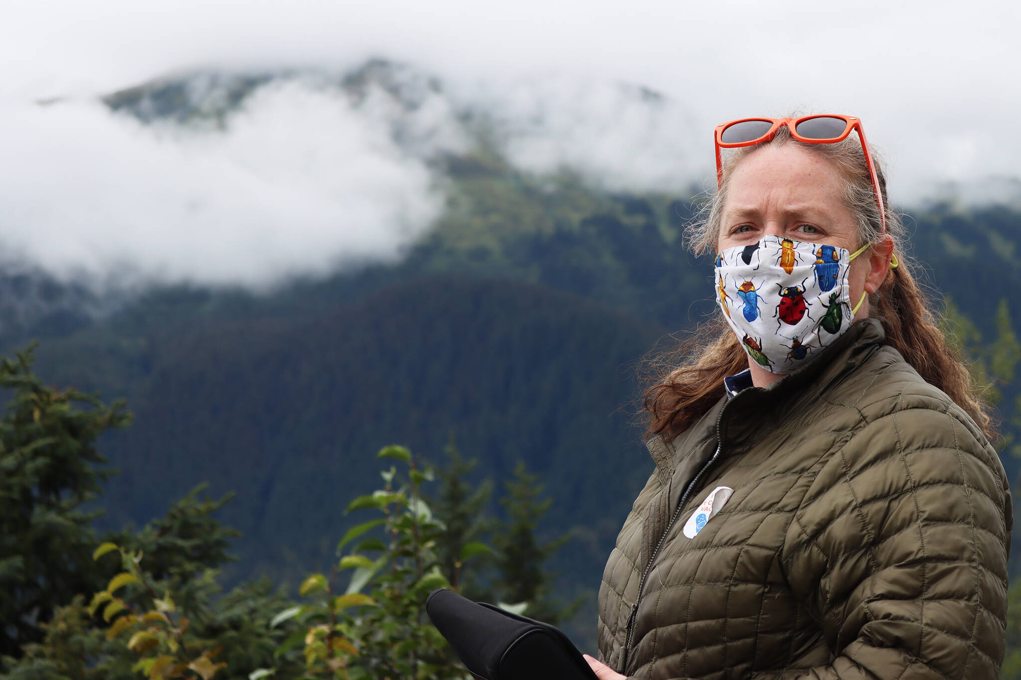 Elizabeth Graham, entomologist for the U.S. Forest Service, talks about the black-headed budworm outbreak in front of a spot on Mount McGinnis that shows the effects of defoliation. (Ben Hohenstatt / Juneau Empire)