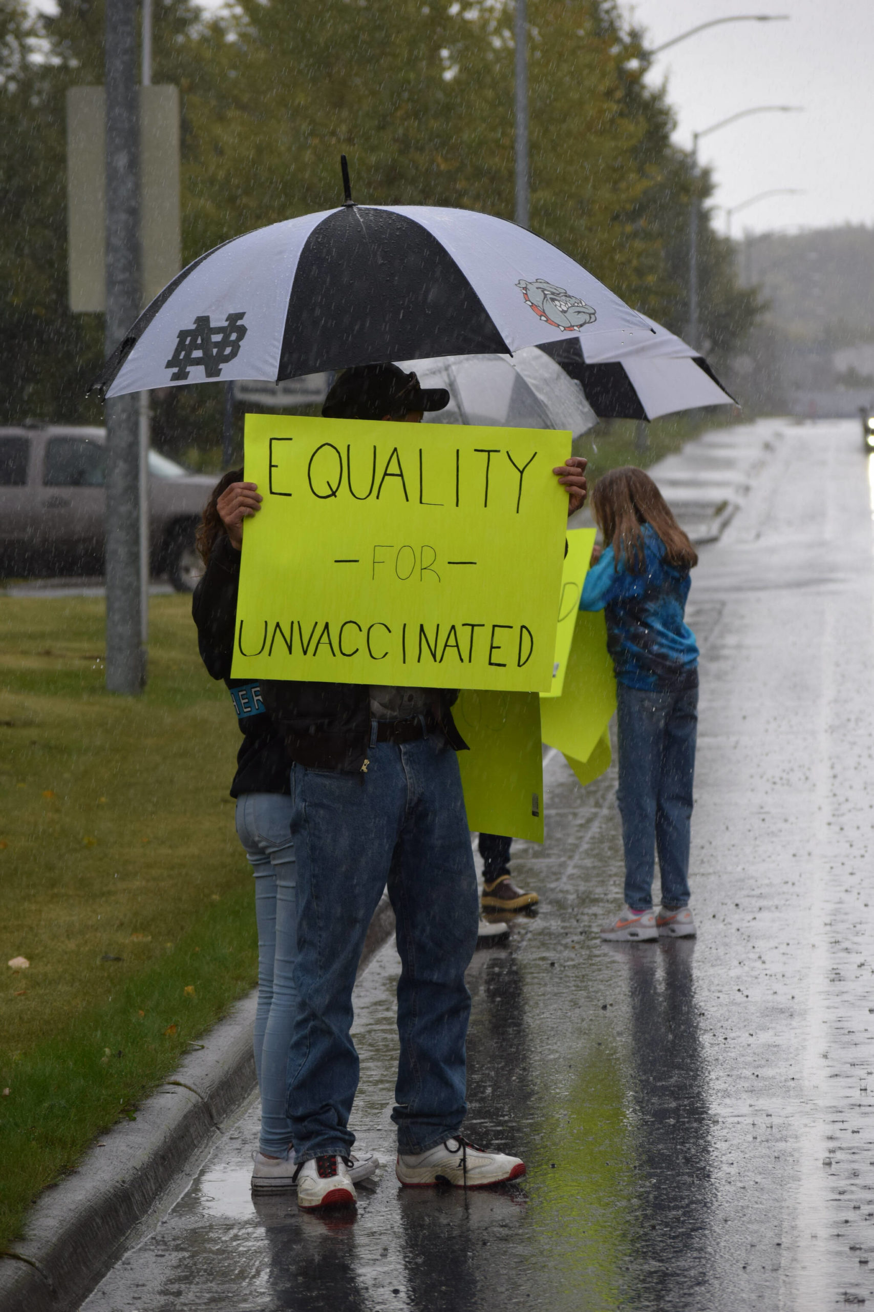 Protesters stands outside the George A. Navarre Borough Admin building in Soldotna on Tuesday, Sept. 14, 2021. (Camille Botello/Peninsula Clarion)