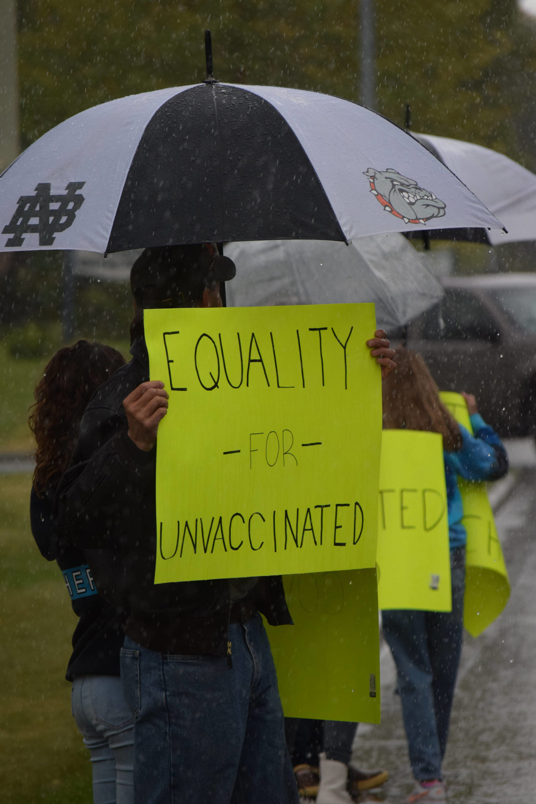 Protesters stand outside the George A. Navarre Borough Admin building in Soldotna on Tuesday, Sept. 14, 2021. (Camille Botello/Peninsula Clarion)