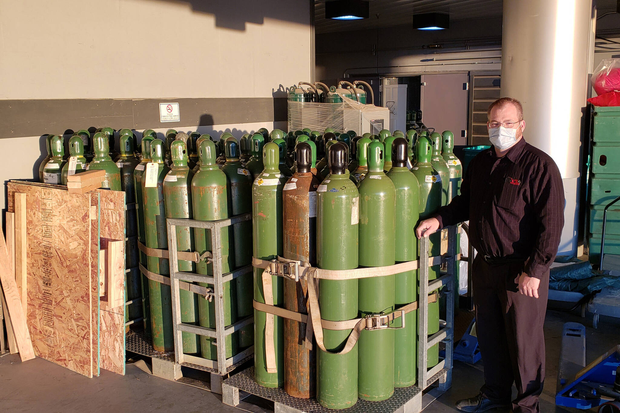 Harrison Smith, South Peninsula Hospital Facilities Manager, stands by medical oxygen tanks on Tuesday, Sept. 22, 2021, at the hospital in Homer, Alaska. Smith, a certified medical gas technician, has been involved with the med-gas system management at South Peninsula Hospital for 18 years. (Photo by Derotha Ferraro / South Peninsula Hospital)