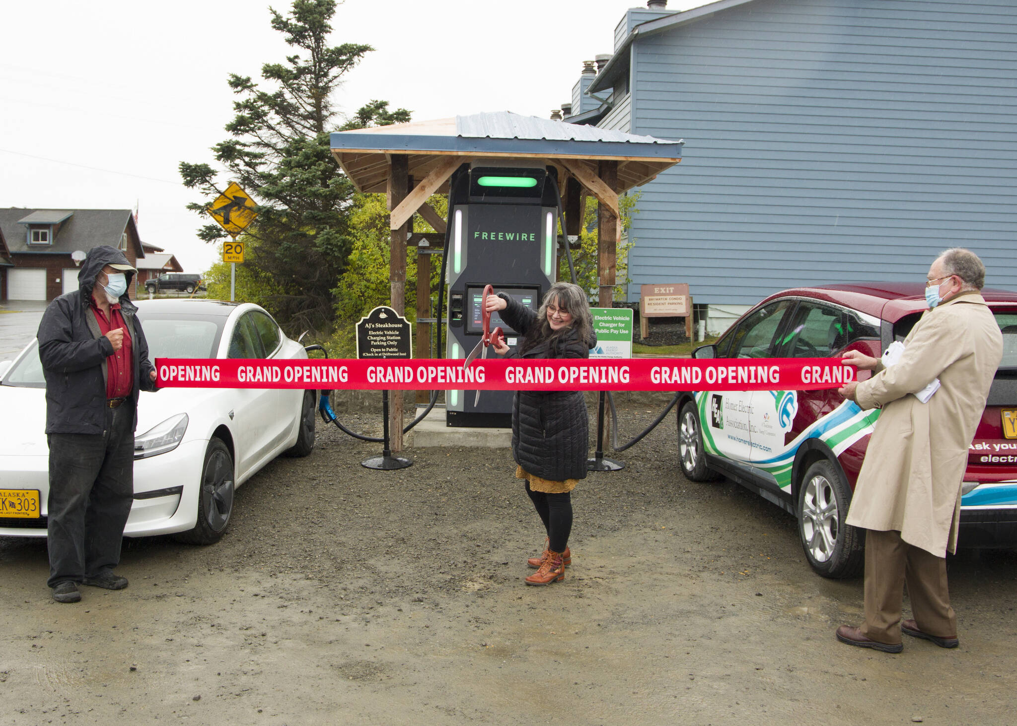 Adrienne Sweeney cuts the grand opening ribbon for the new electric vehicle fast-charging station. (Photo by Sarah Knapp/Homer News)