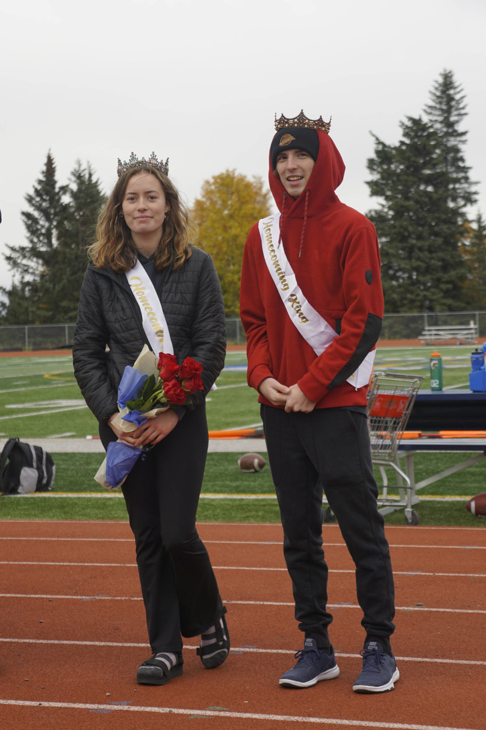 Homecoming Queen Kaylin Anderson, left, and King Kazden Stineff pose after being crowned at the Homer vs. Nikiski junior varsity football game on Saturday, Oct. 2, 2021, at Homer High School. (Photo by Michael Armstrong/Homer News)